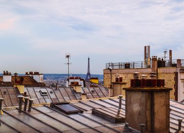 Man on top of a room cleaning a chimney