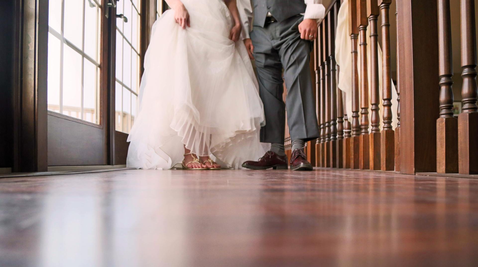 bride and groom showing what shoes they're wearing