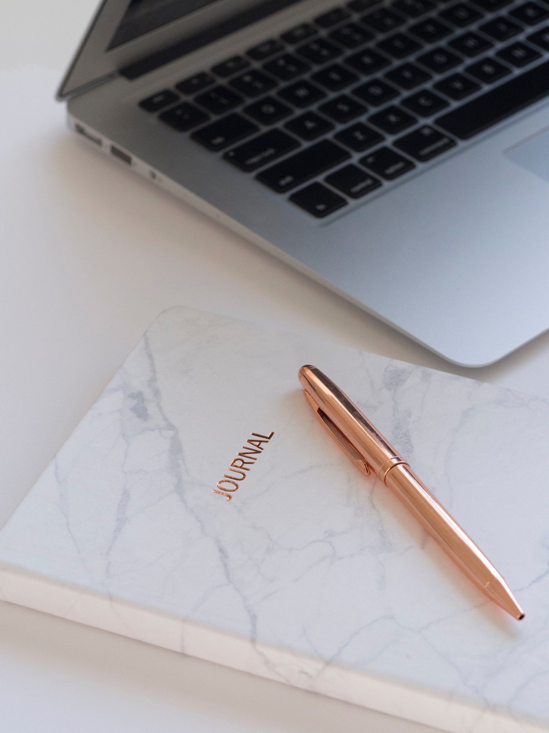 journal entry and a laptop 
