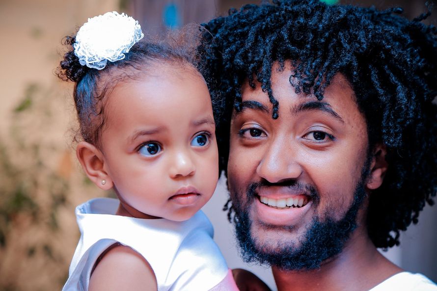 A man is holding a little girl in his arms.