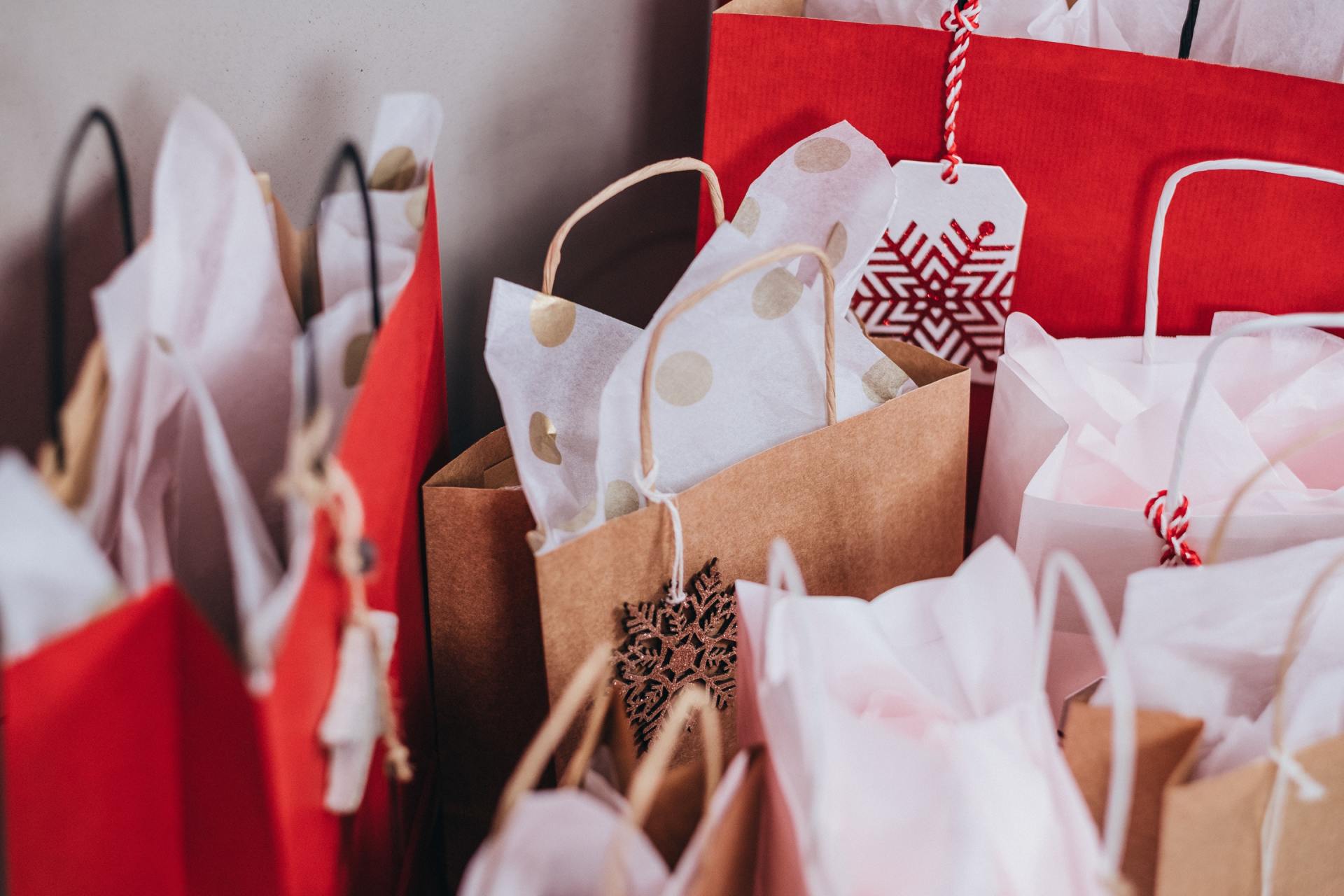A bunch of shopping bags with one that has a snowflake on it