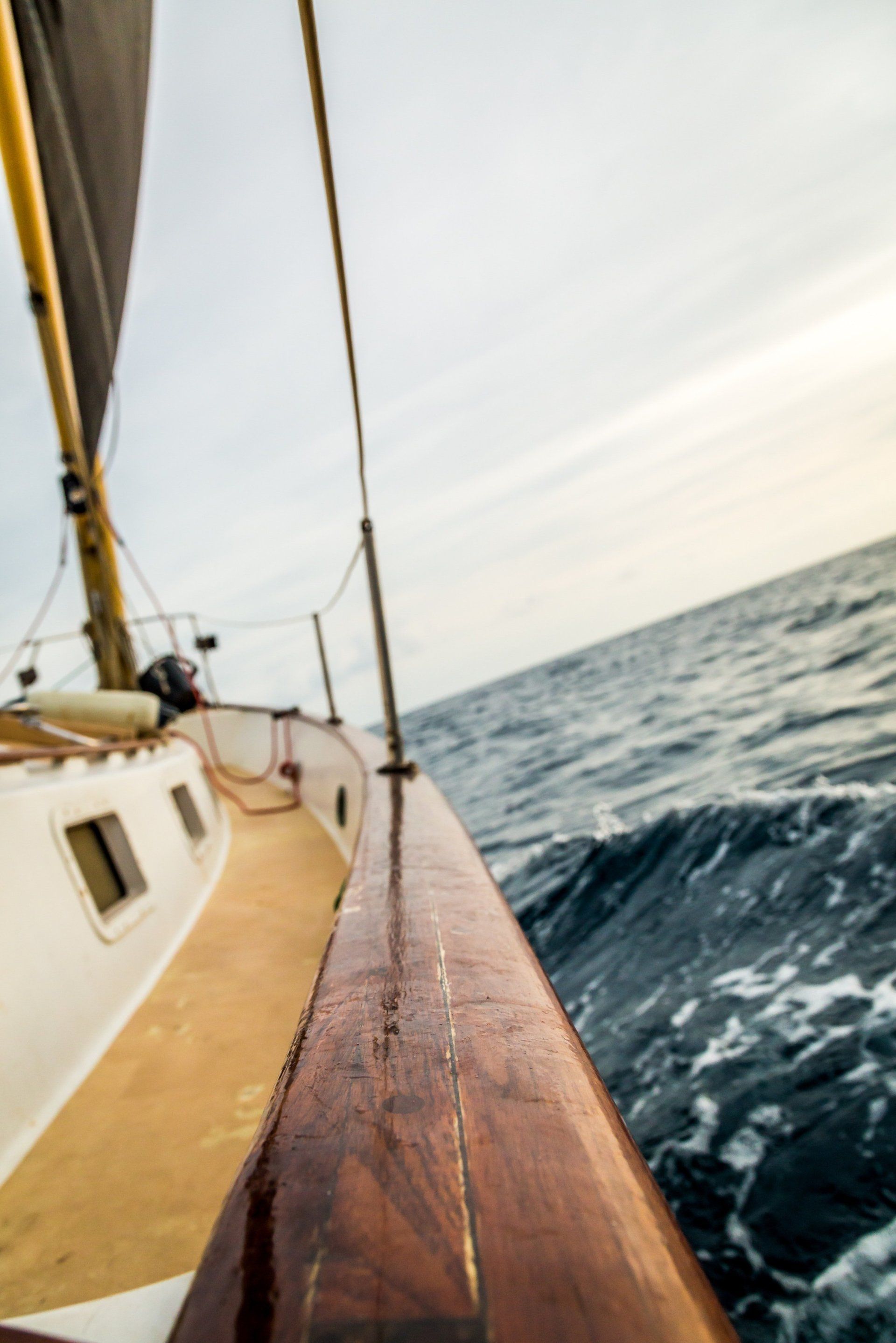 A sailboat is floating on top of a large body of water.