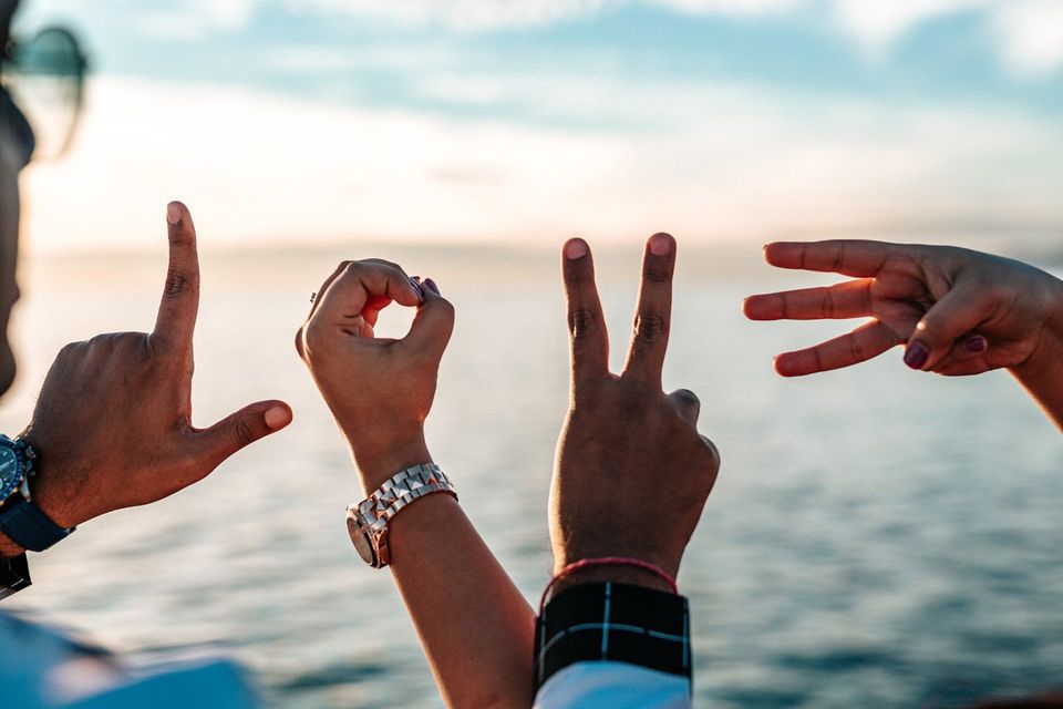 LOVE Spelled out with human hand gestures