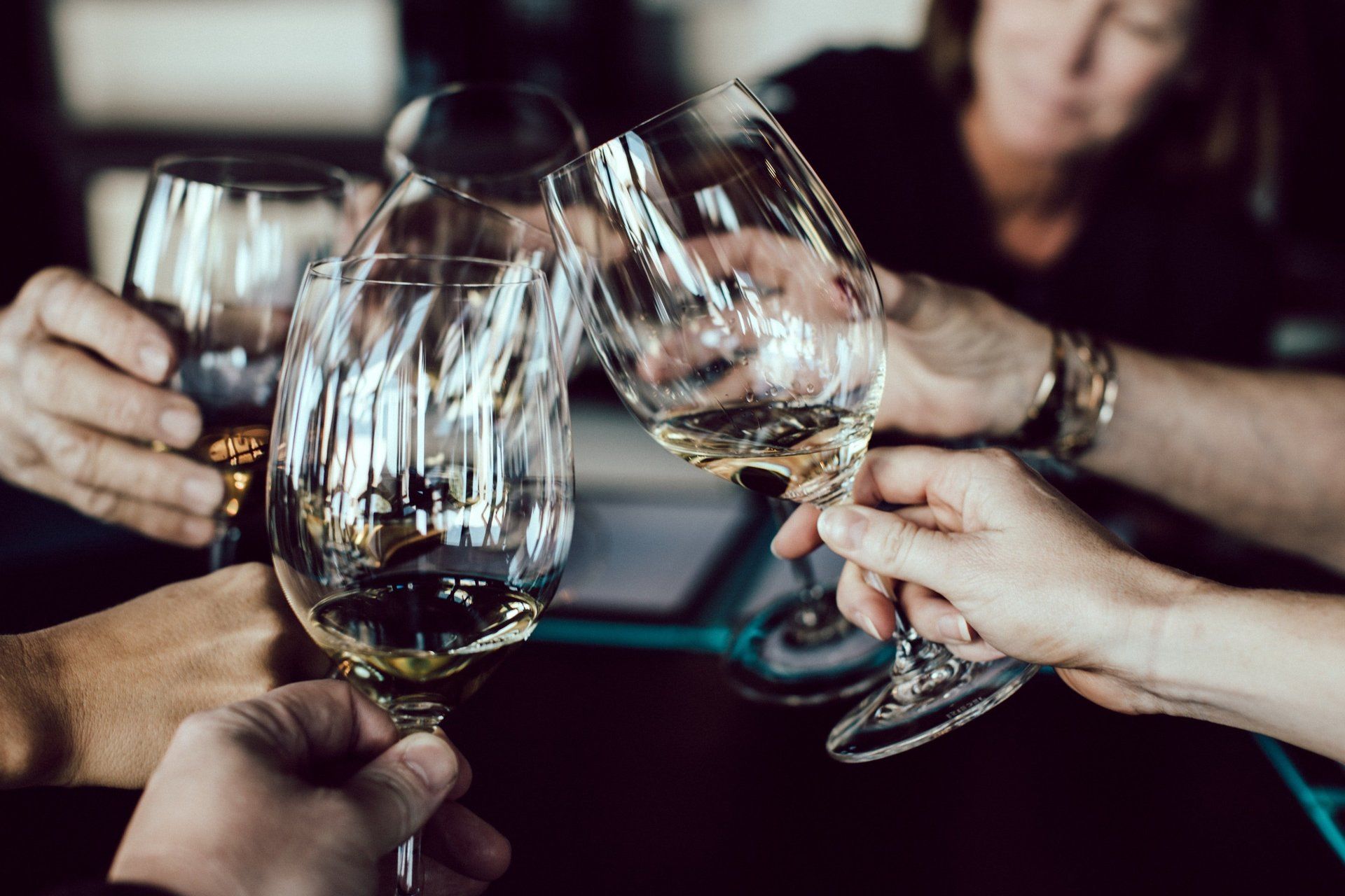 a group of people are toasting with wine glasses
