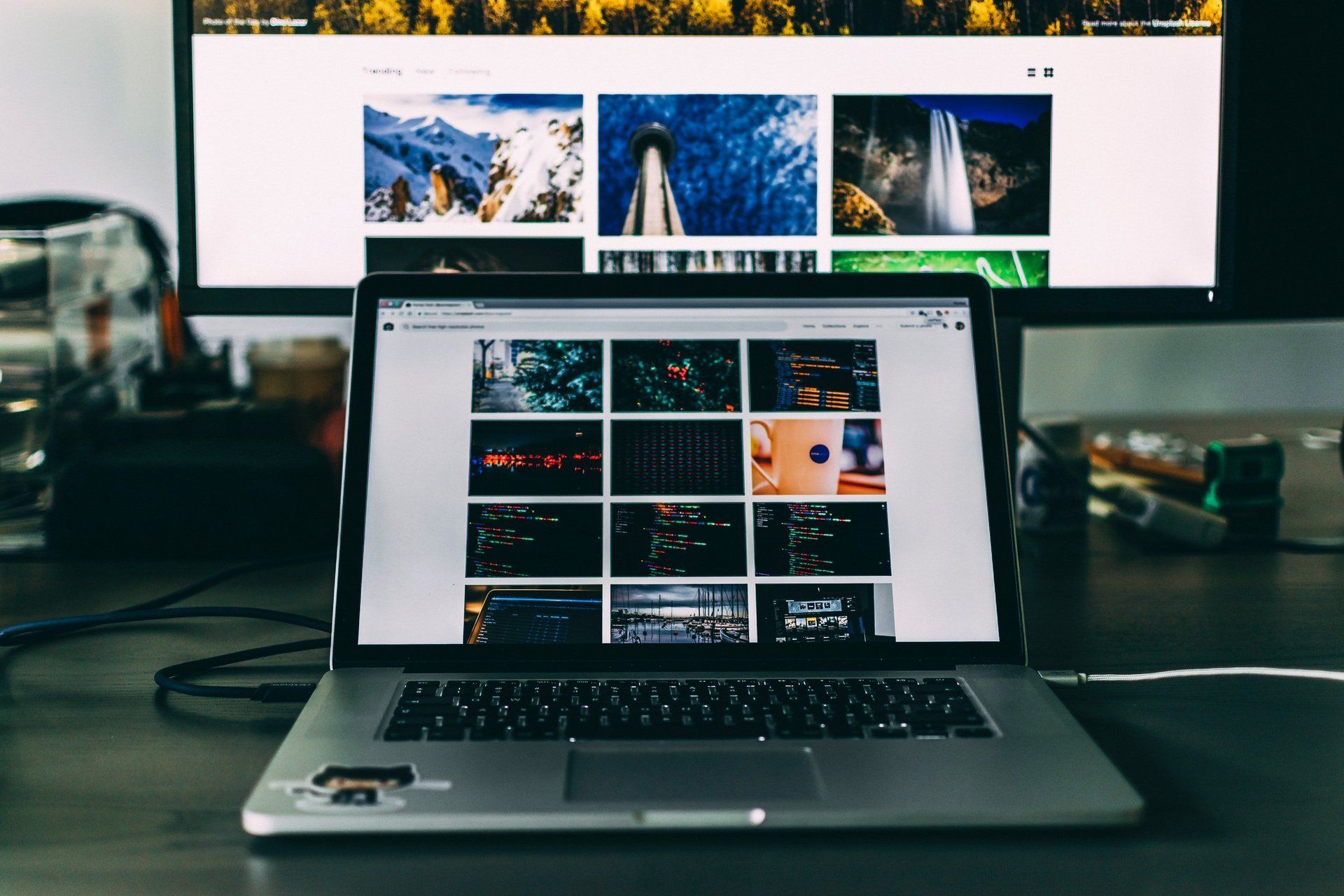 A laptop is open to a website with a lot of pictures on it