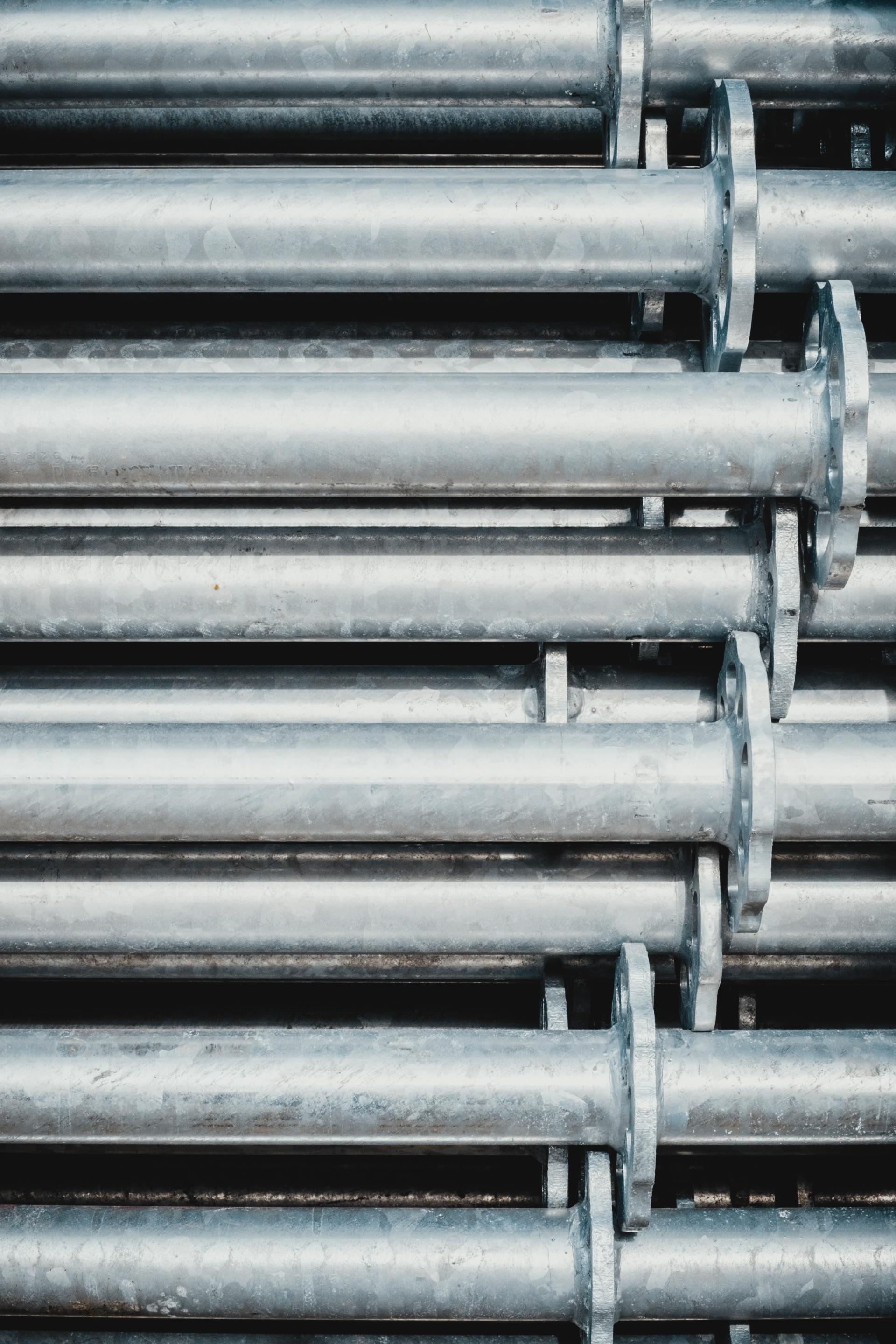 A close up of a bunch of metal pipes stacked on top of each other.