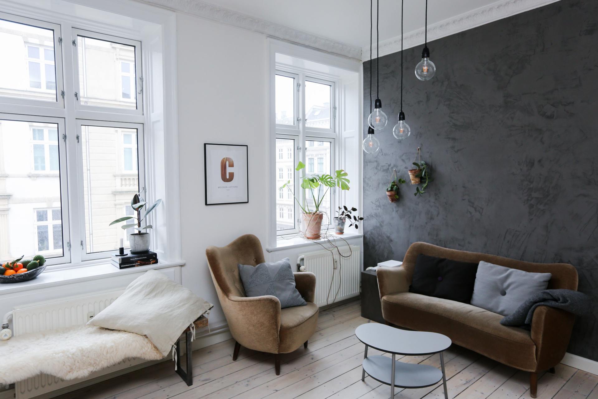 A living room with a couch , chair and table