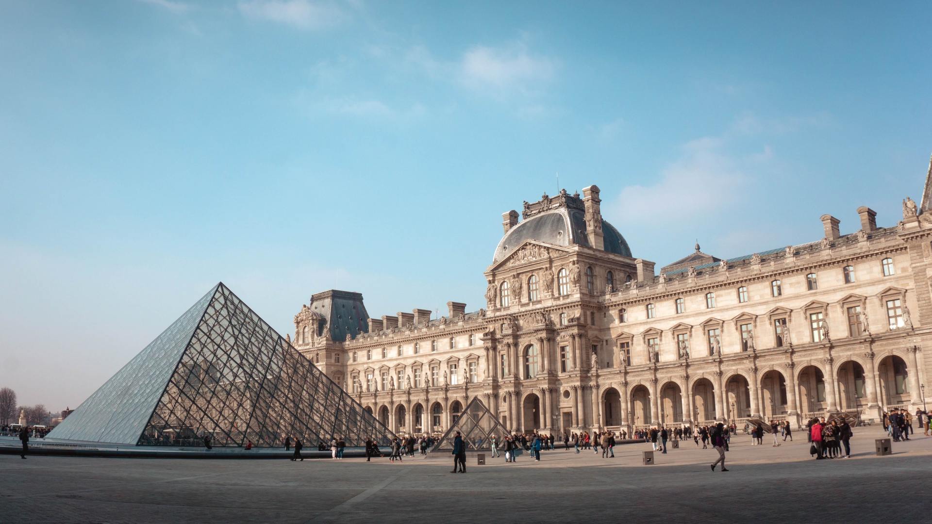 The Louvre Museum with a pyramid in front of it