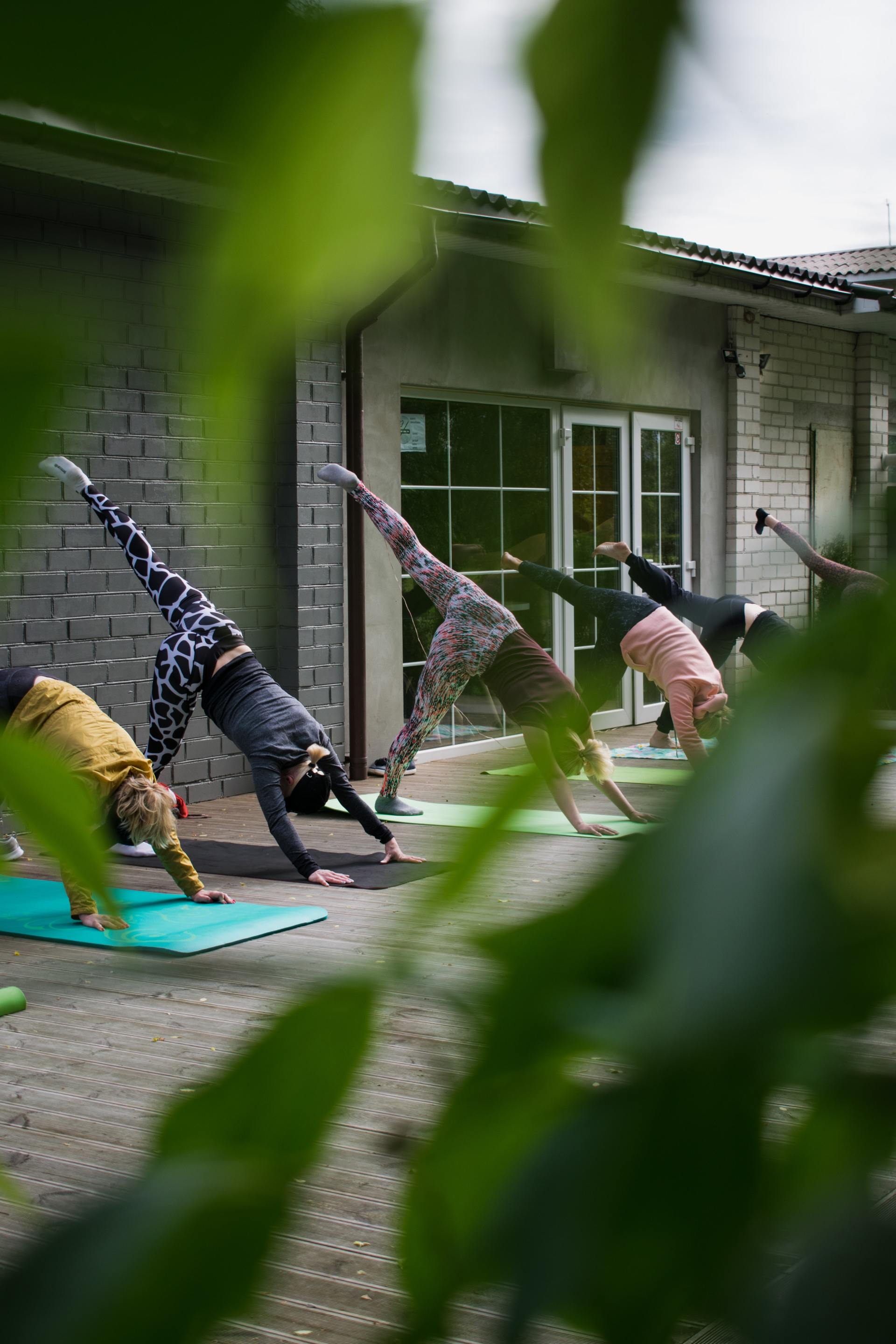 A group of people are doing yoga on a deck.