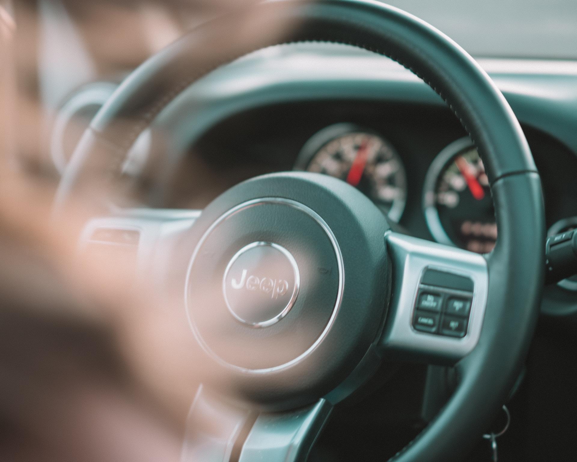 A close up of a steering wheel in a jeep