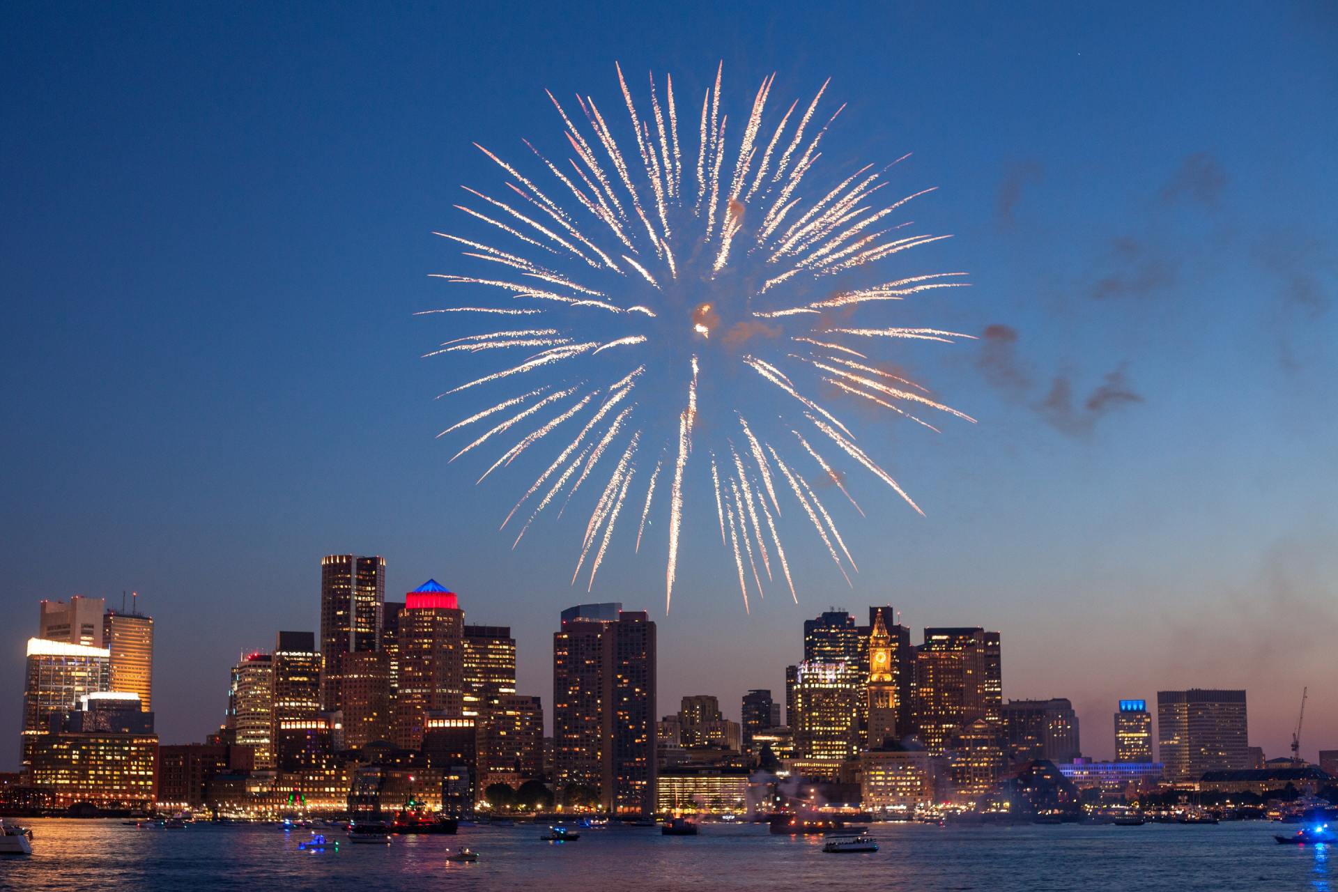 A fireworks display over a city skyline at night