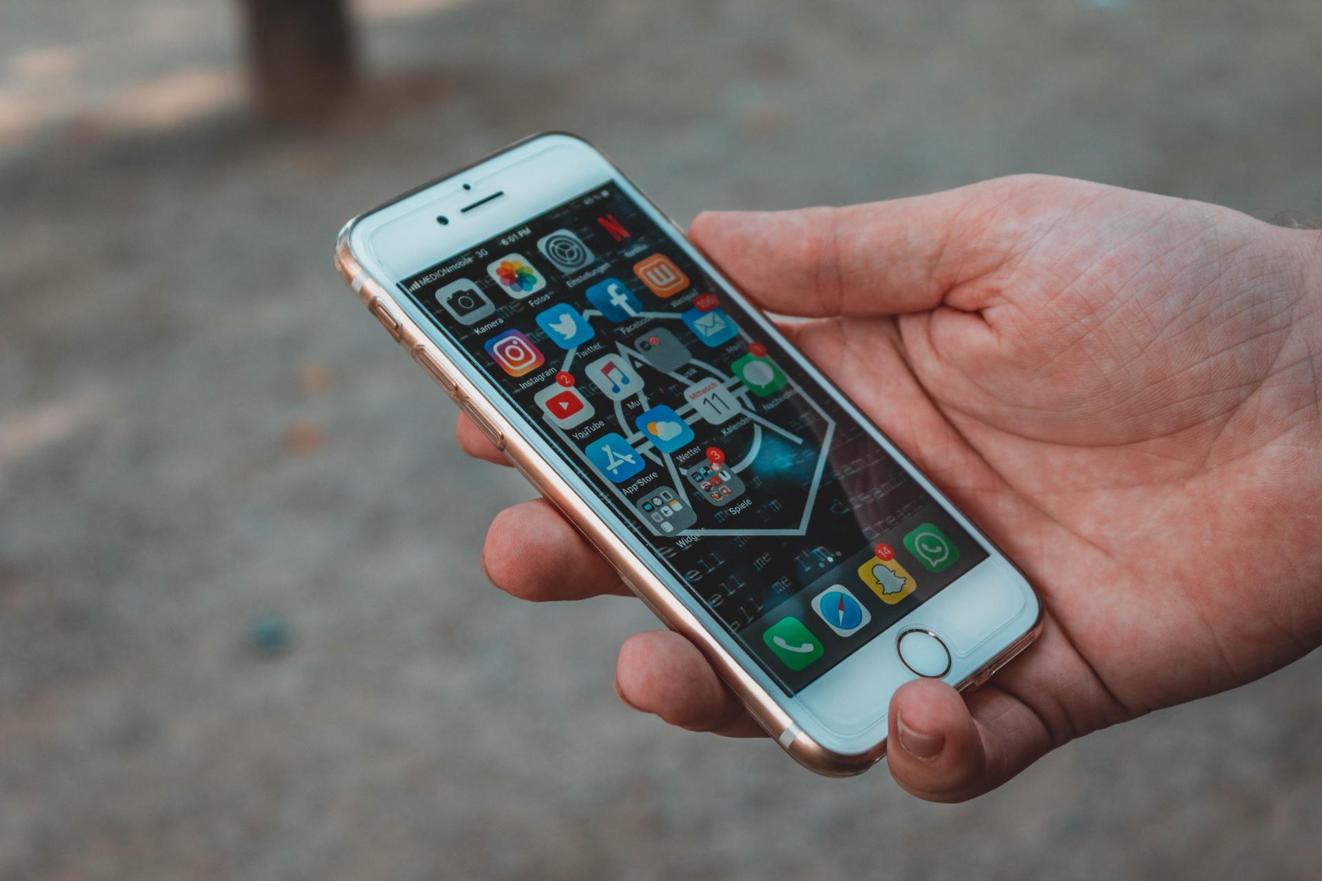 A person is holding a cell phone in their hand.