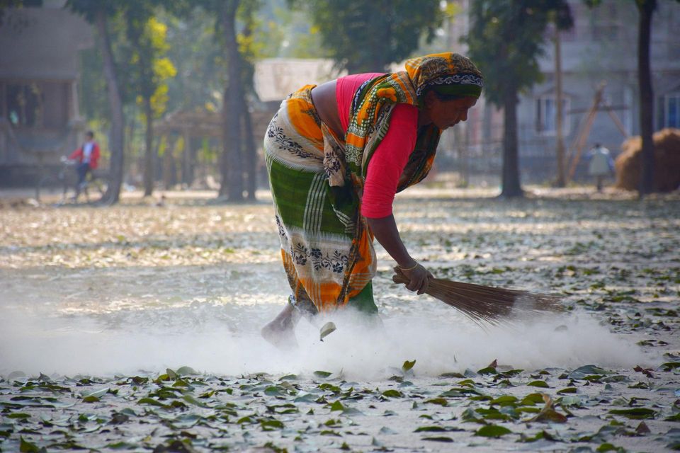 woman sweeping the street
