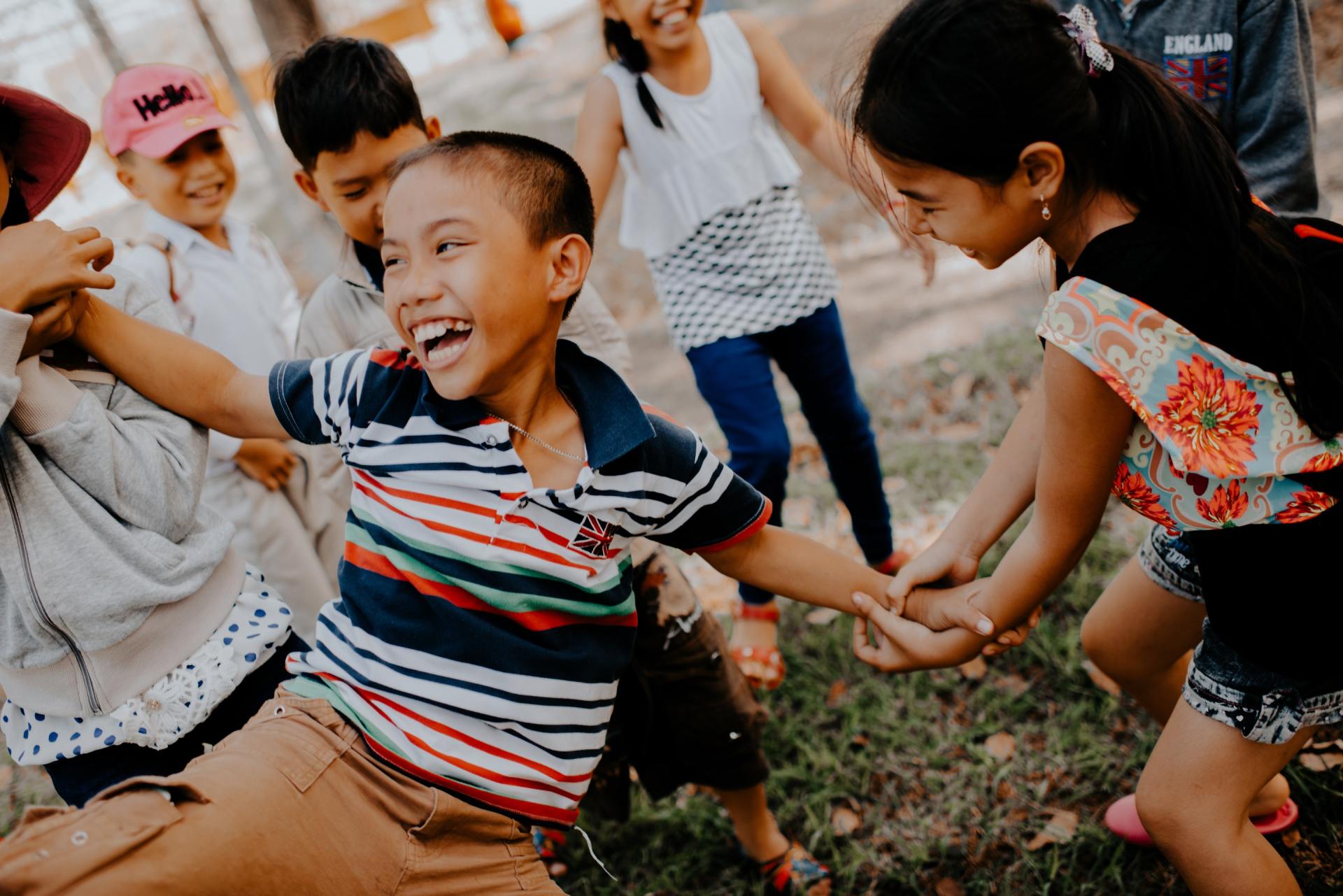 Young children playing together celebrating world happiness