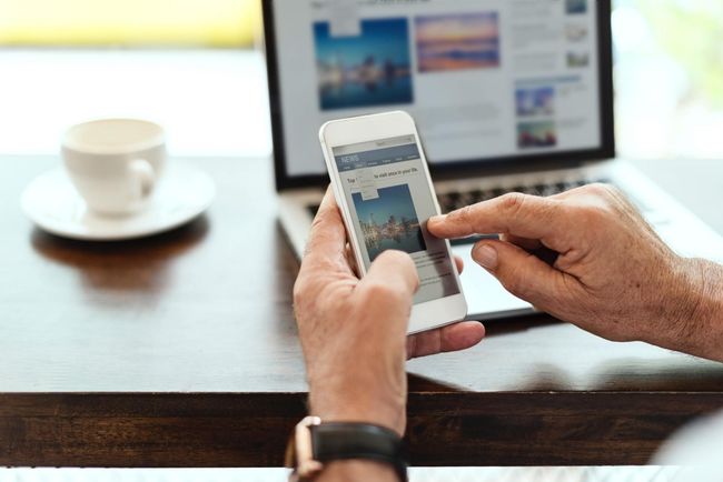 surfing web with mobile phone / laptop