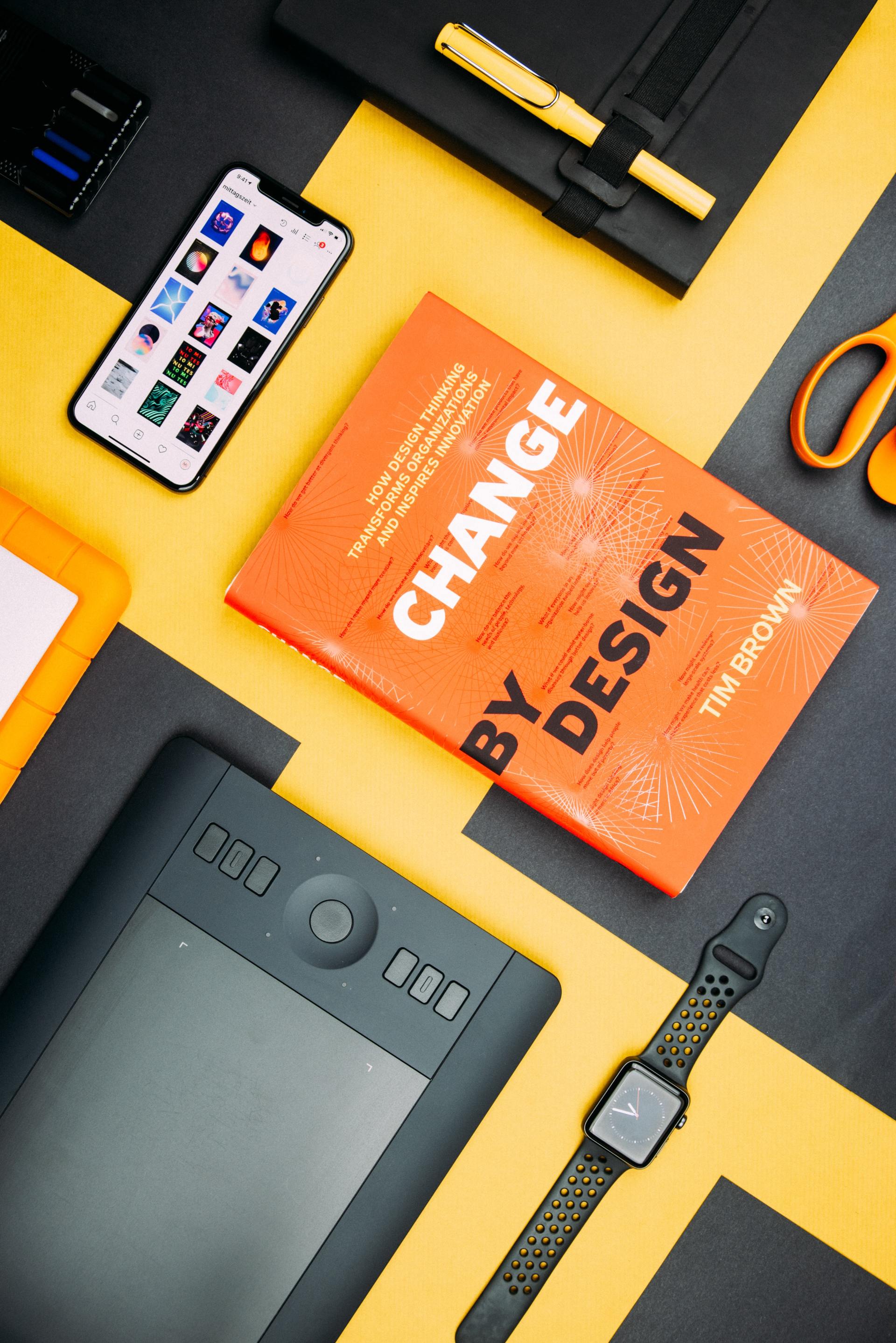 A book titled change by design is on a table
