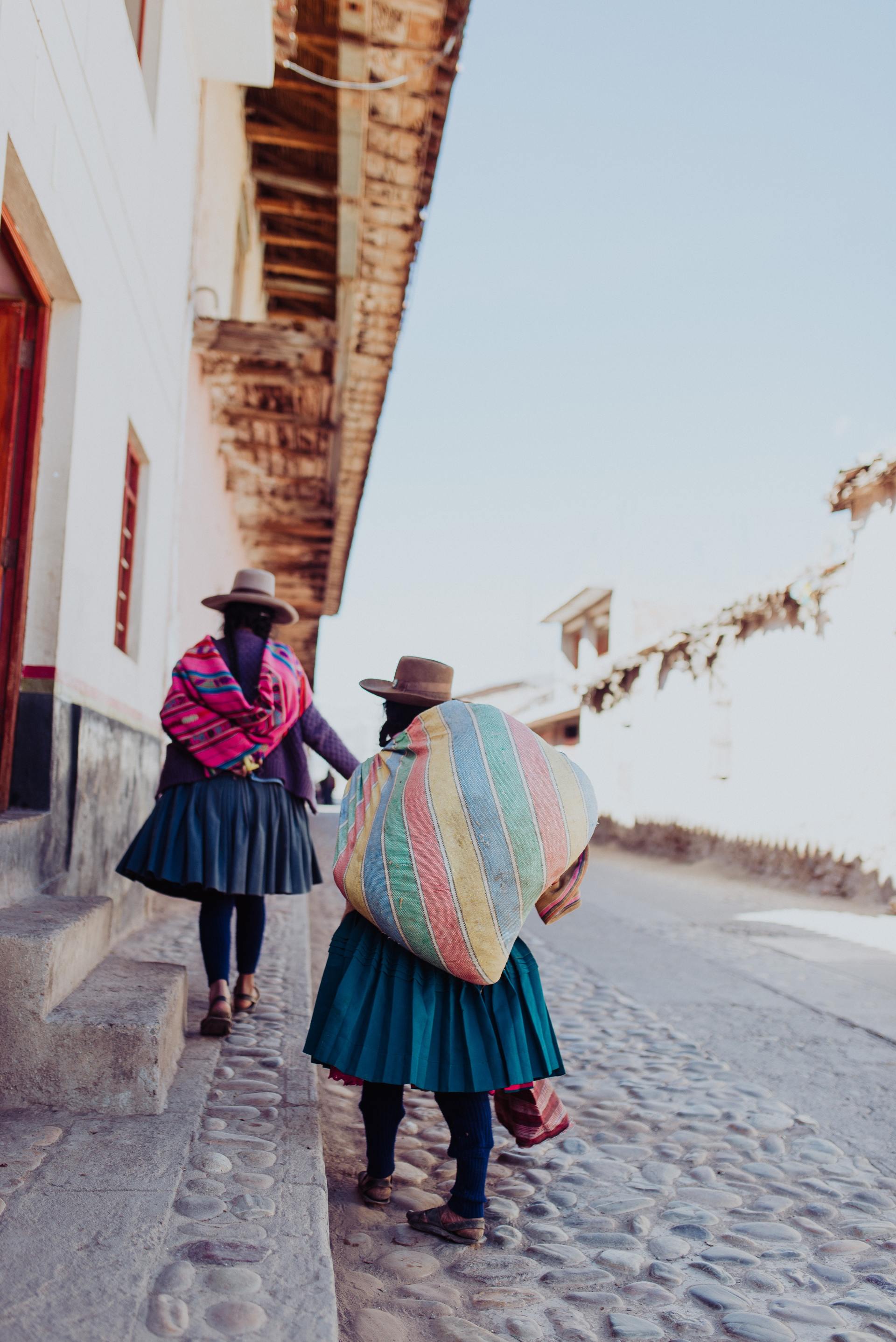 Picture of 2 local women walking along a street.