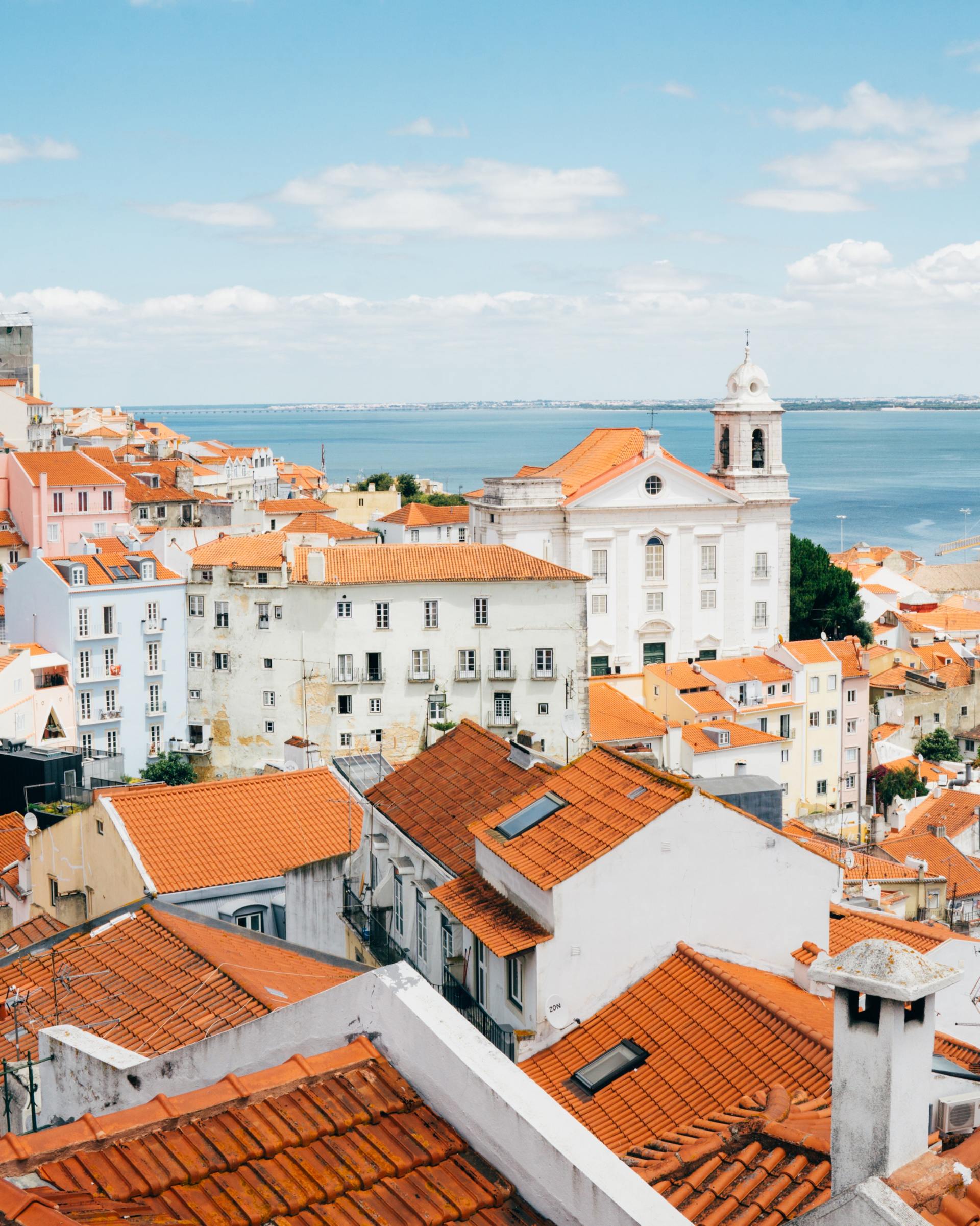 An aerial view of a city with orange tiled roofs