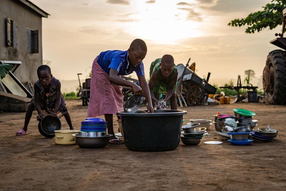 children doing dishes in wash tub