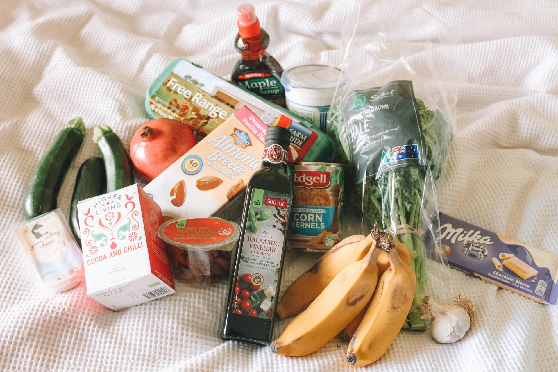 A bunch of food is sitting on a bed.