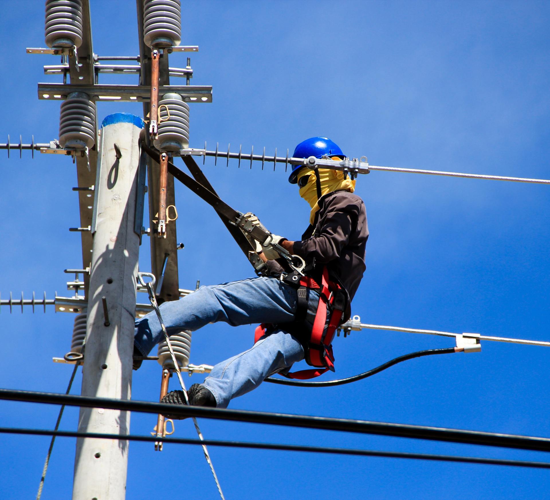 Electrician working on electrical pole