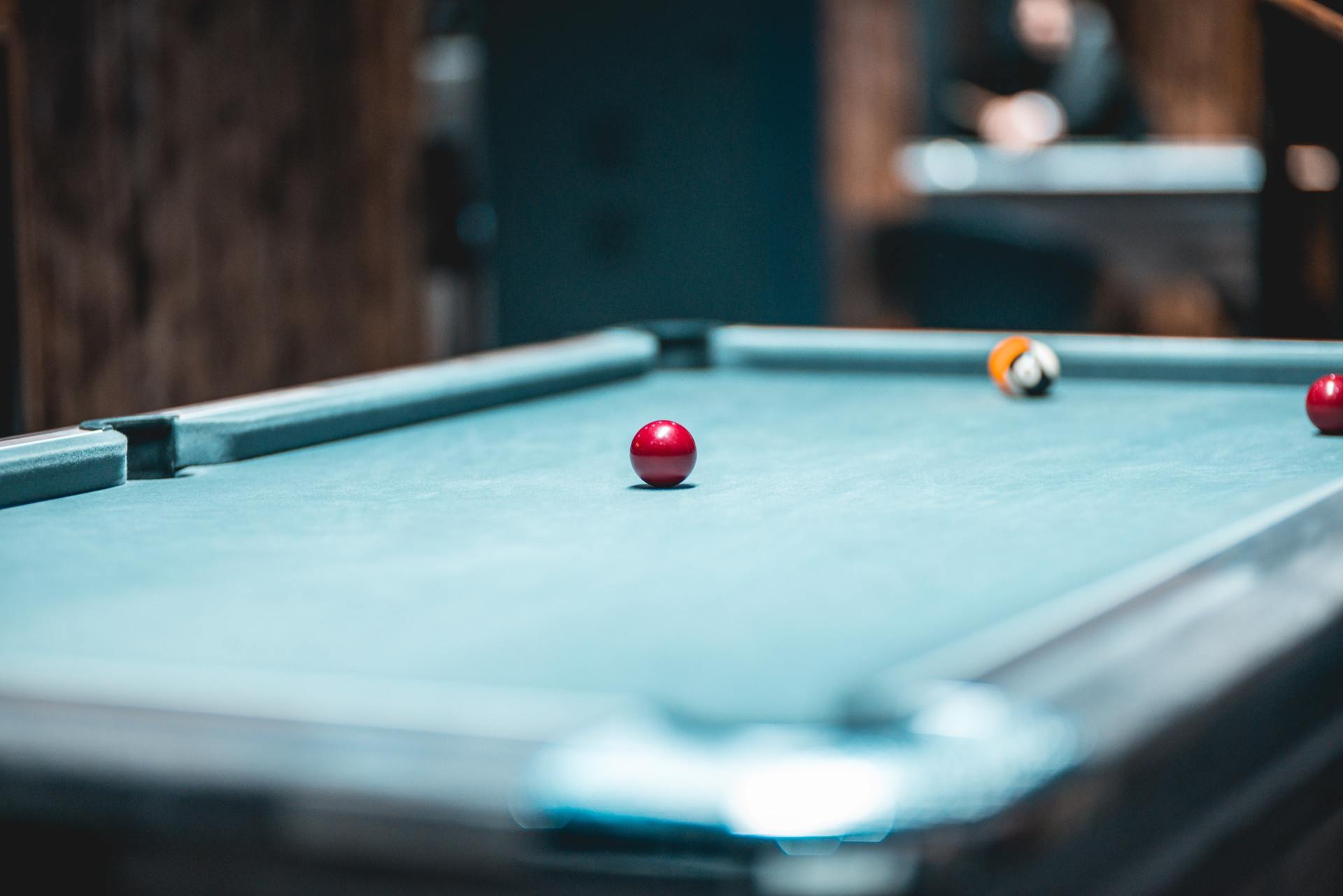 A pool table with three pool balls on it.