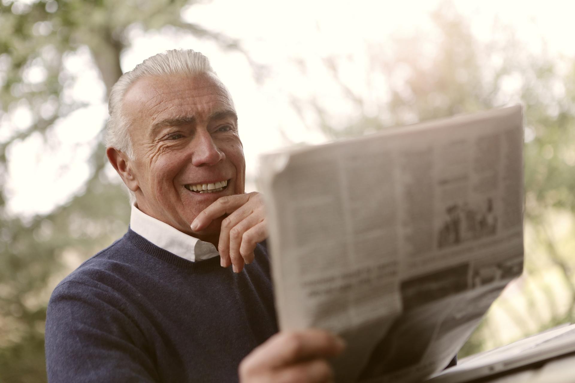 A senior reading a newspaper
