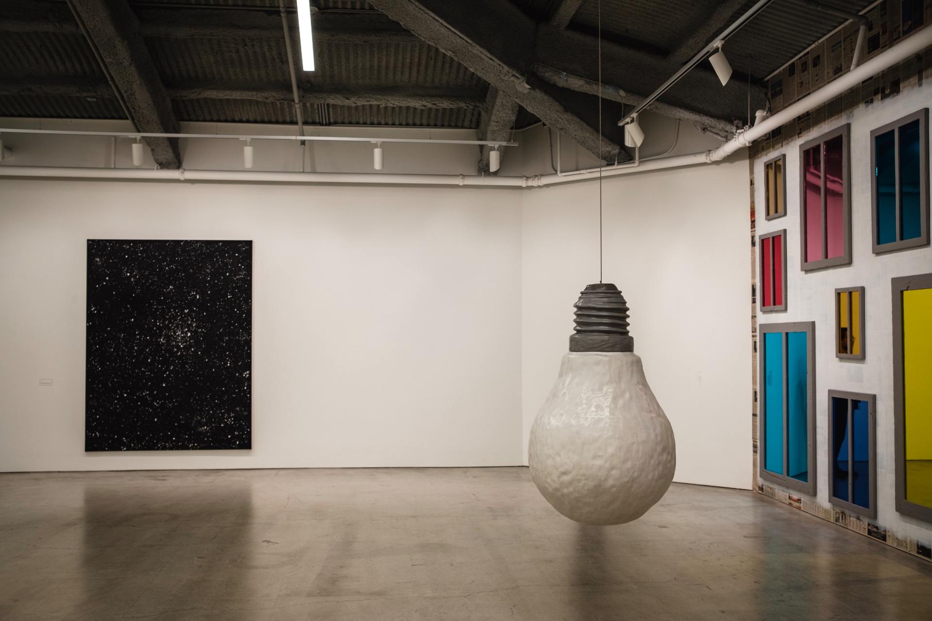 a large light bulb is hanging from the ceiling in a room .