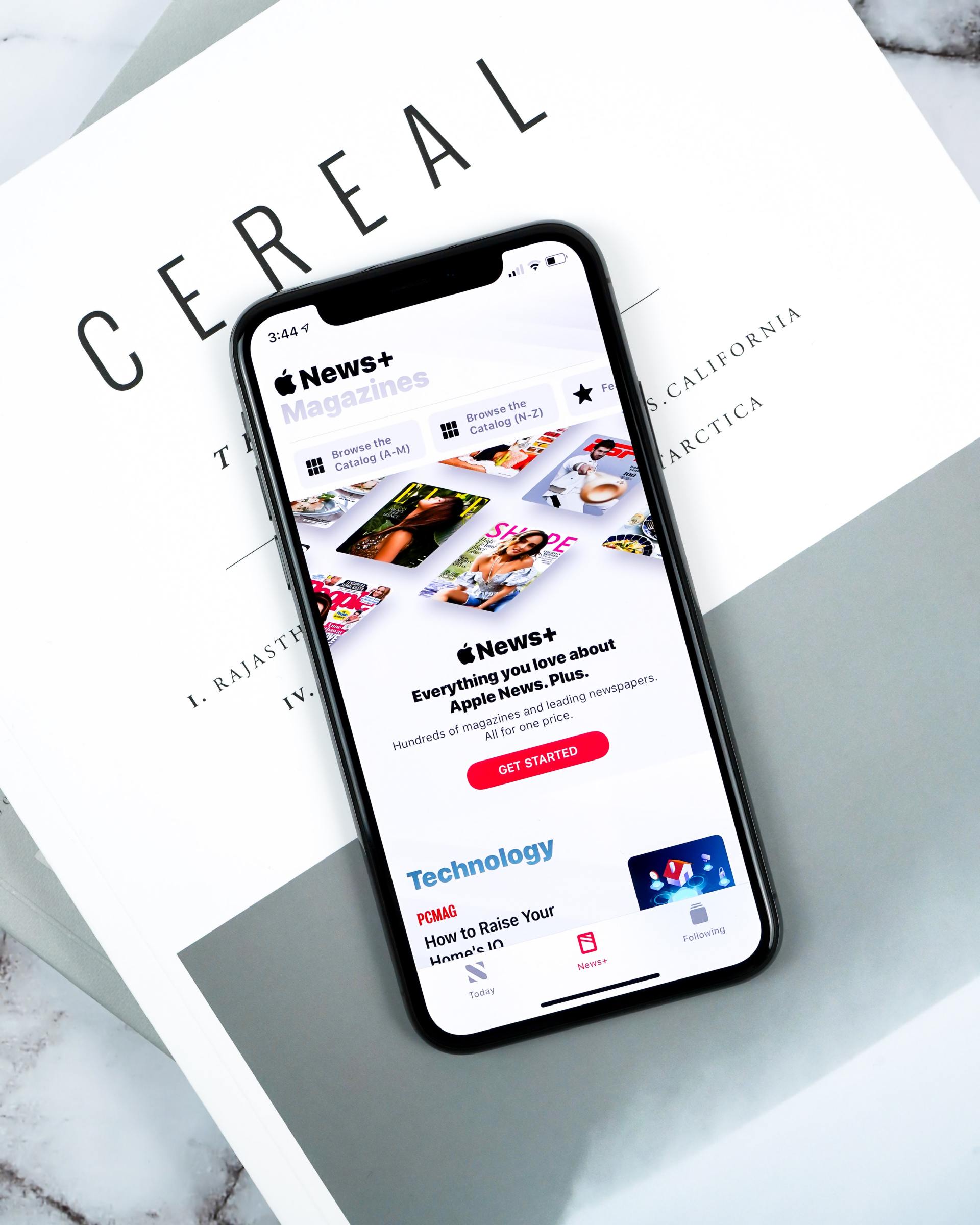 A cell phone is sitting on top of a piece of paper that says cereal.
