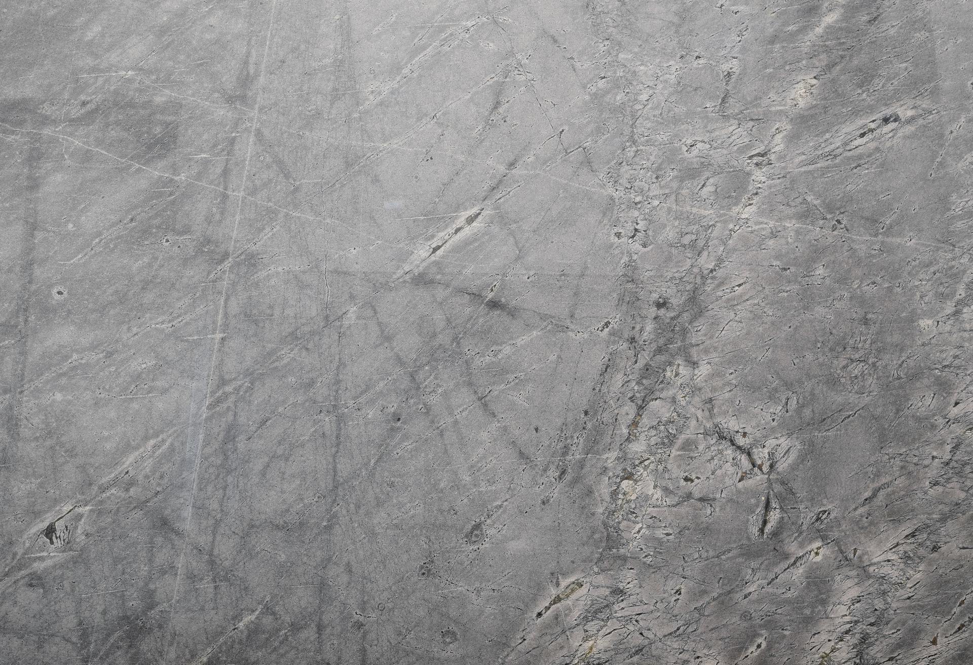 Gray concrete texture with scratches and markings.