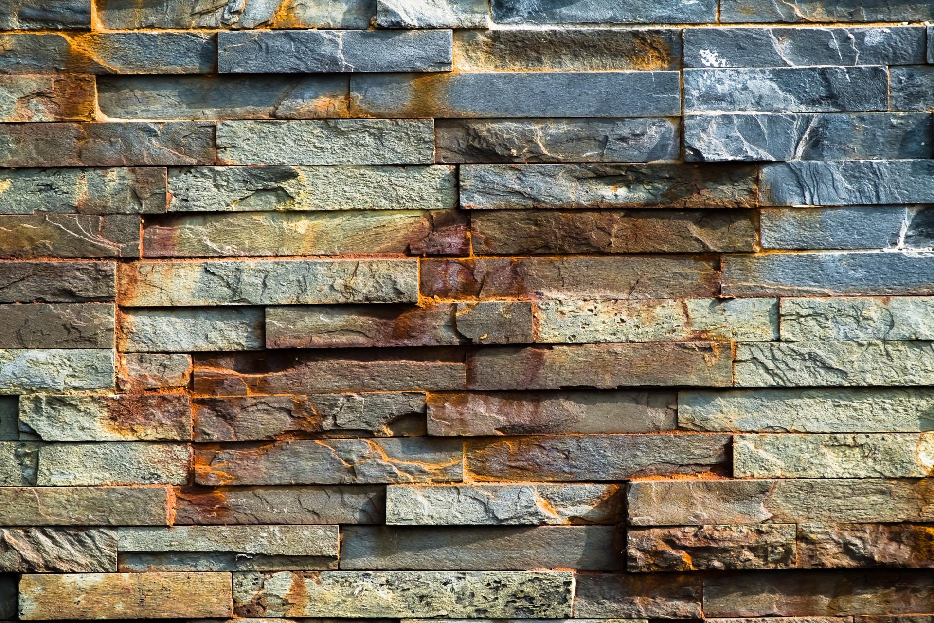 A close up of a brick wall with rust on it.