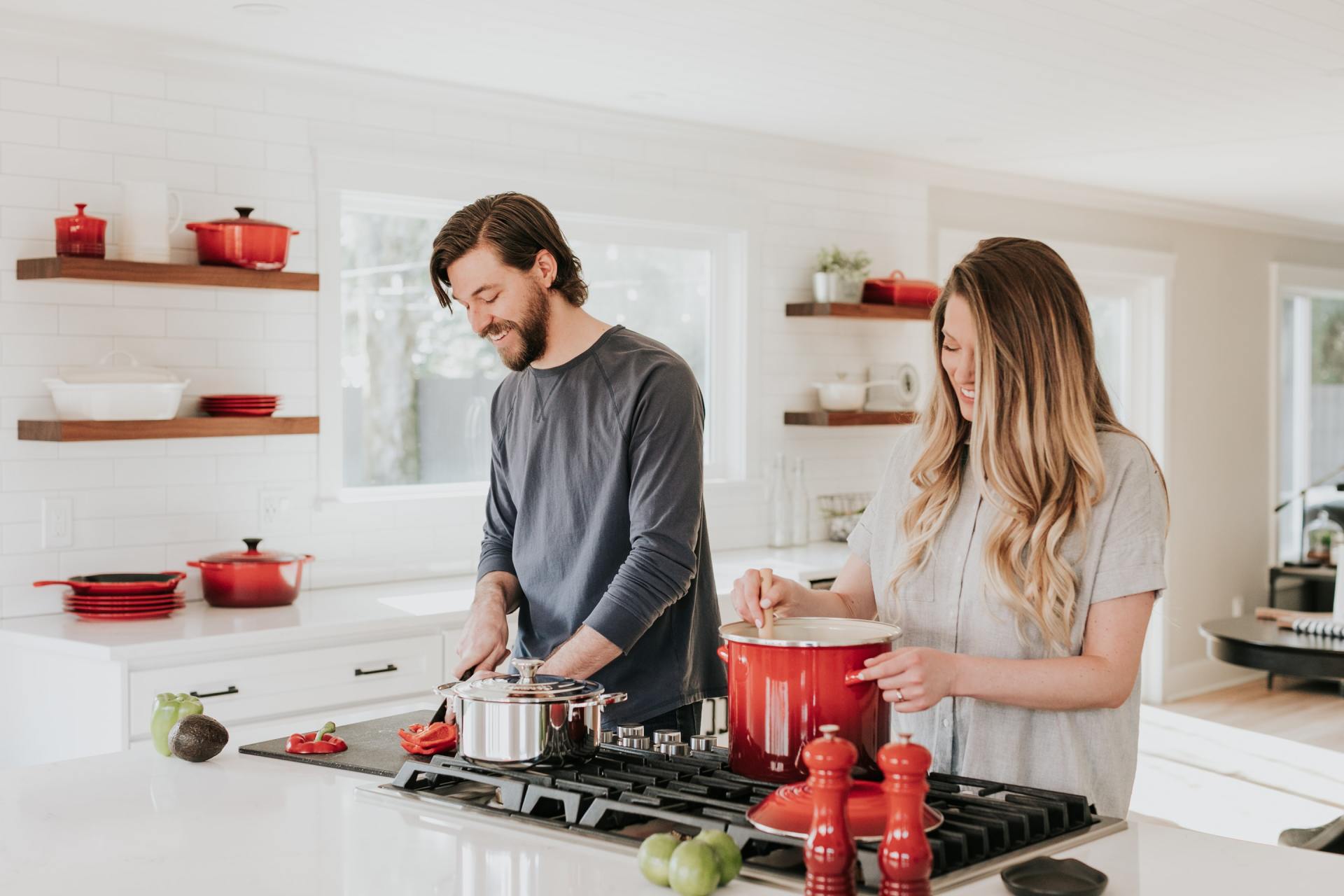 A young couple cooking together in the kitchen of their accessory dwelling unit (ADU) casita