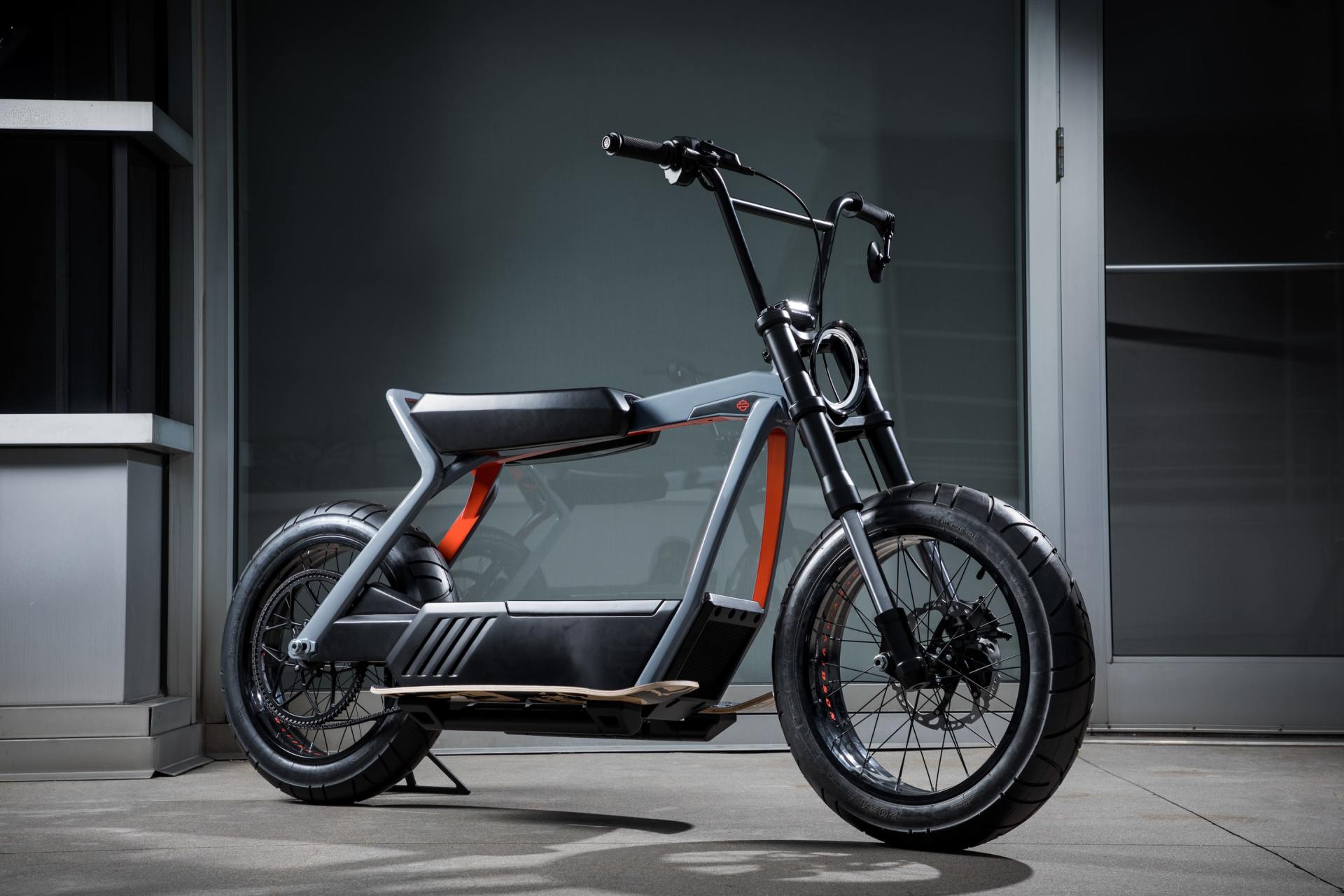 An electric motorcycle is parked in front of a building.
