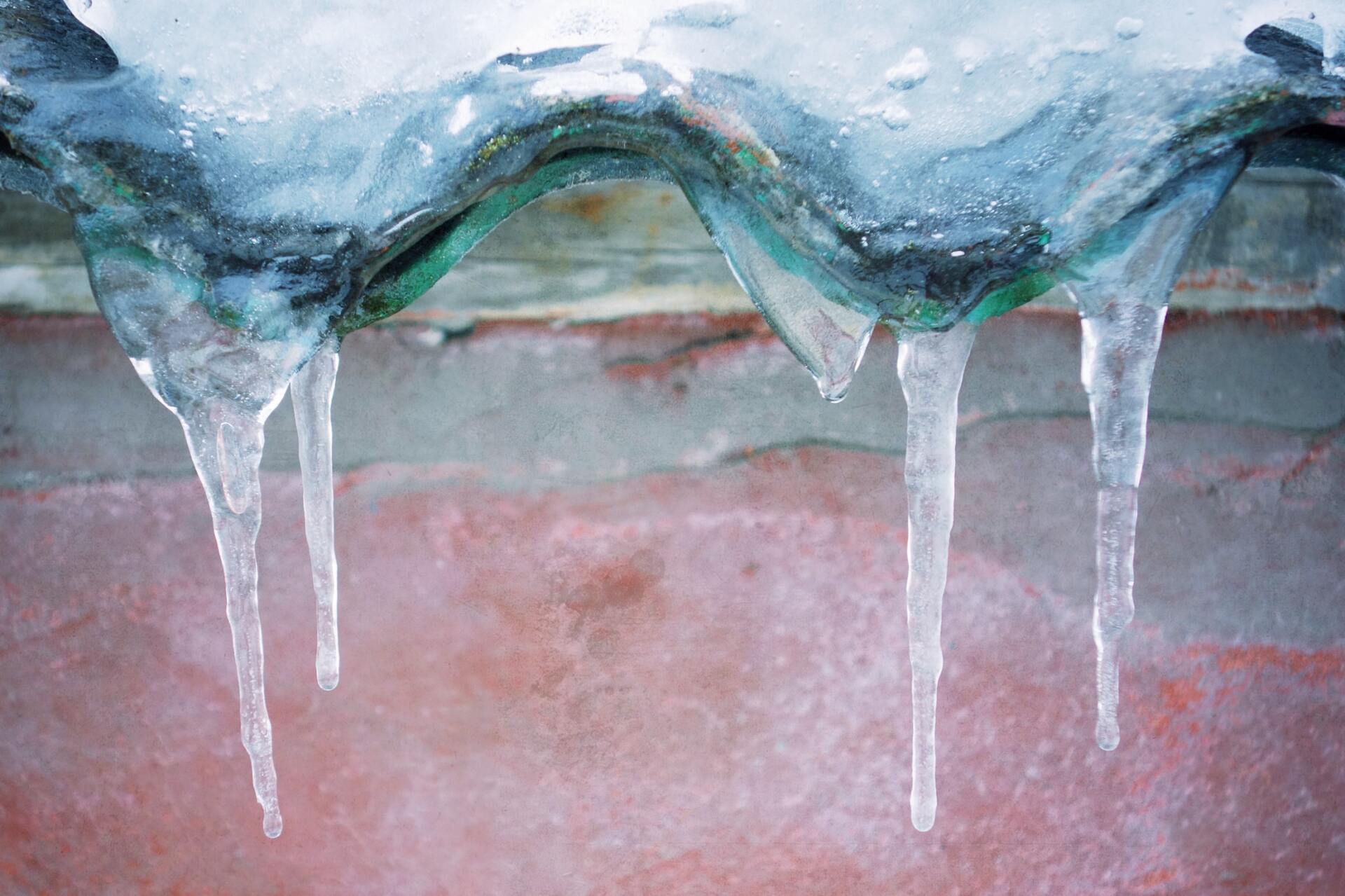 Thick Ice Dam & Icicles on Side of Building