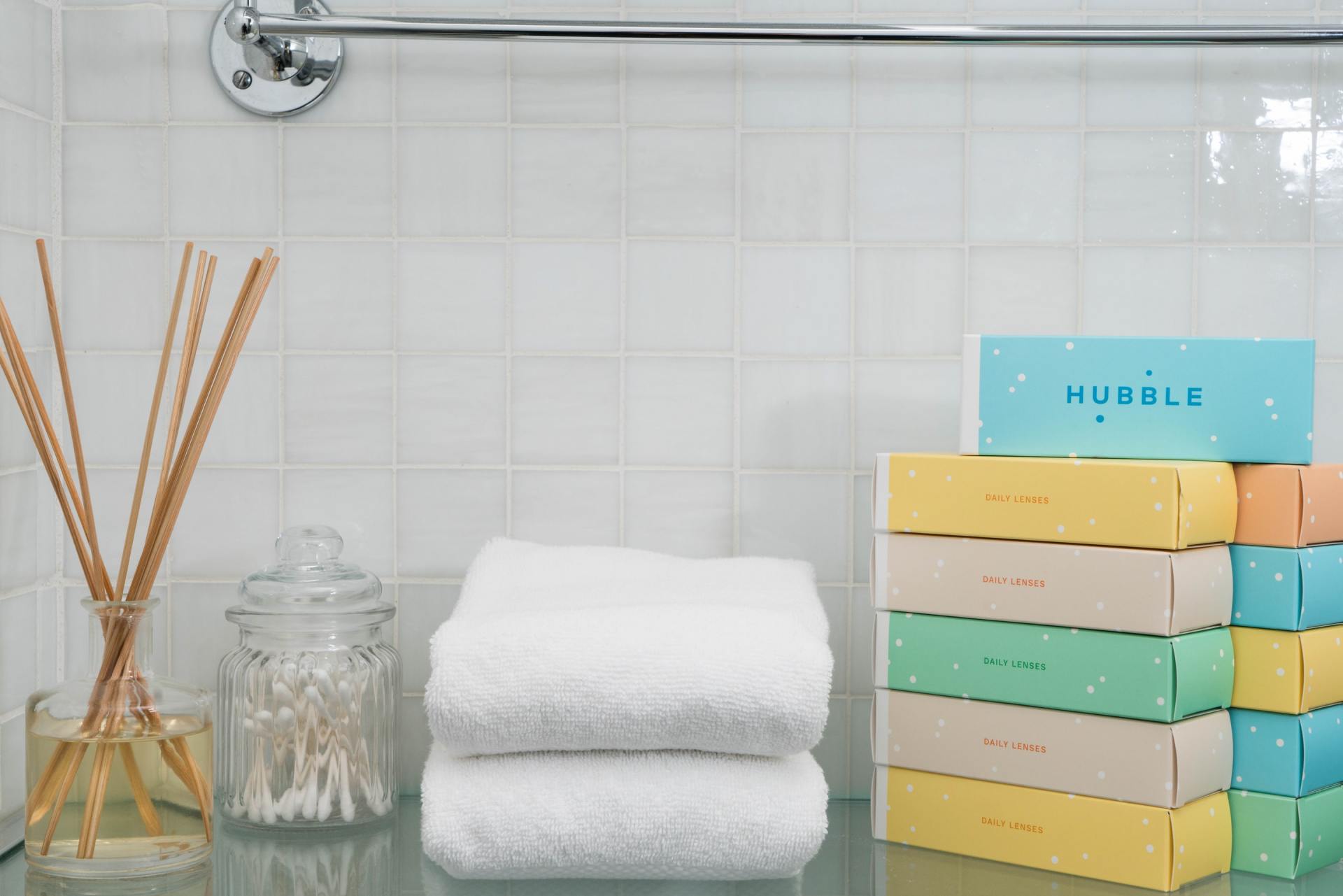Table with Towels, Reed Diffuser Sticks, and Soap Boxes