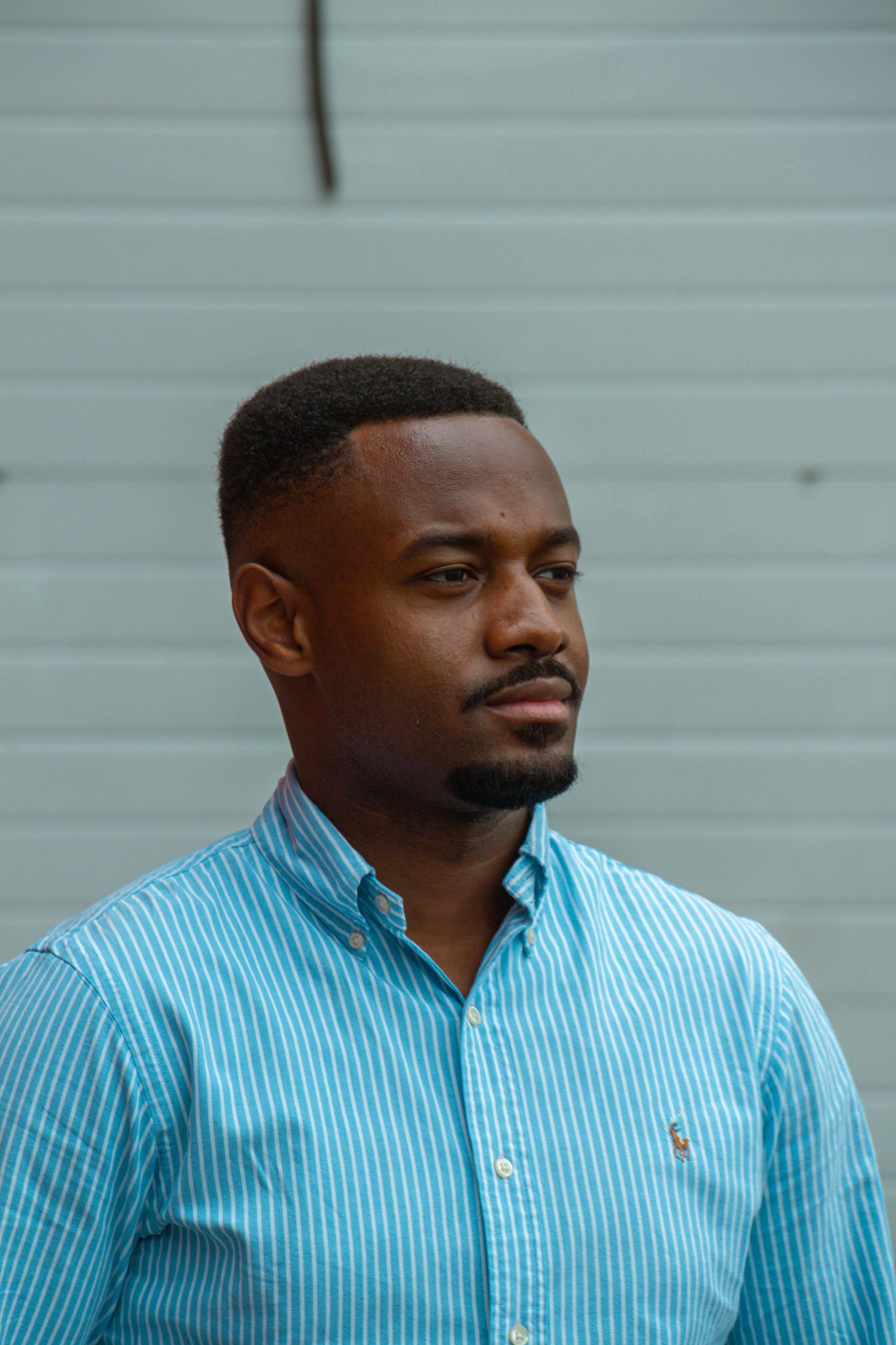 A man with brick wall in the background