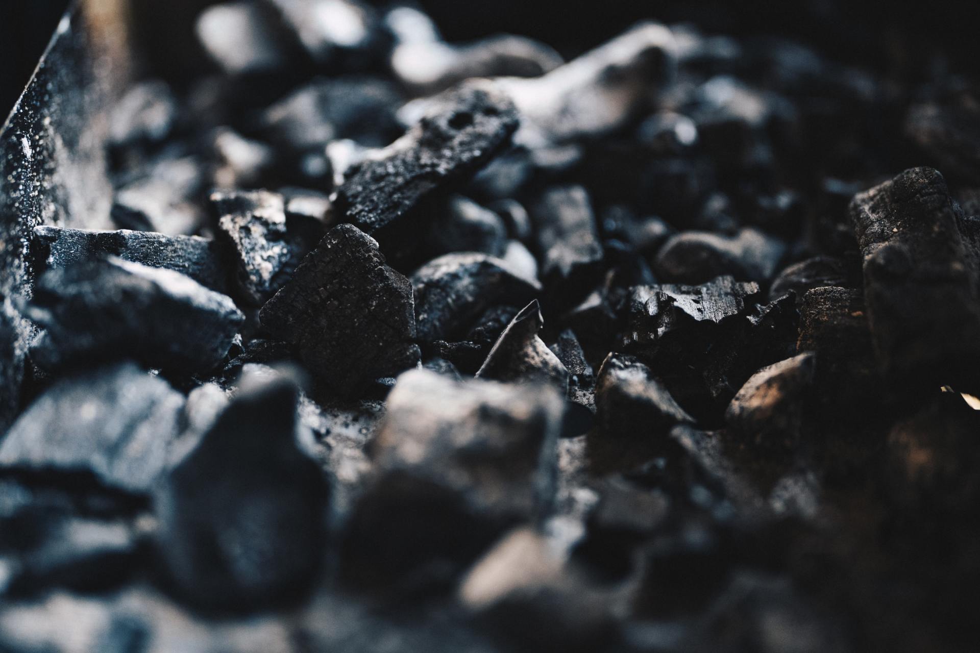 A pile of coal is sitting on a table in a dark room.