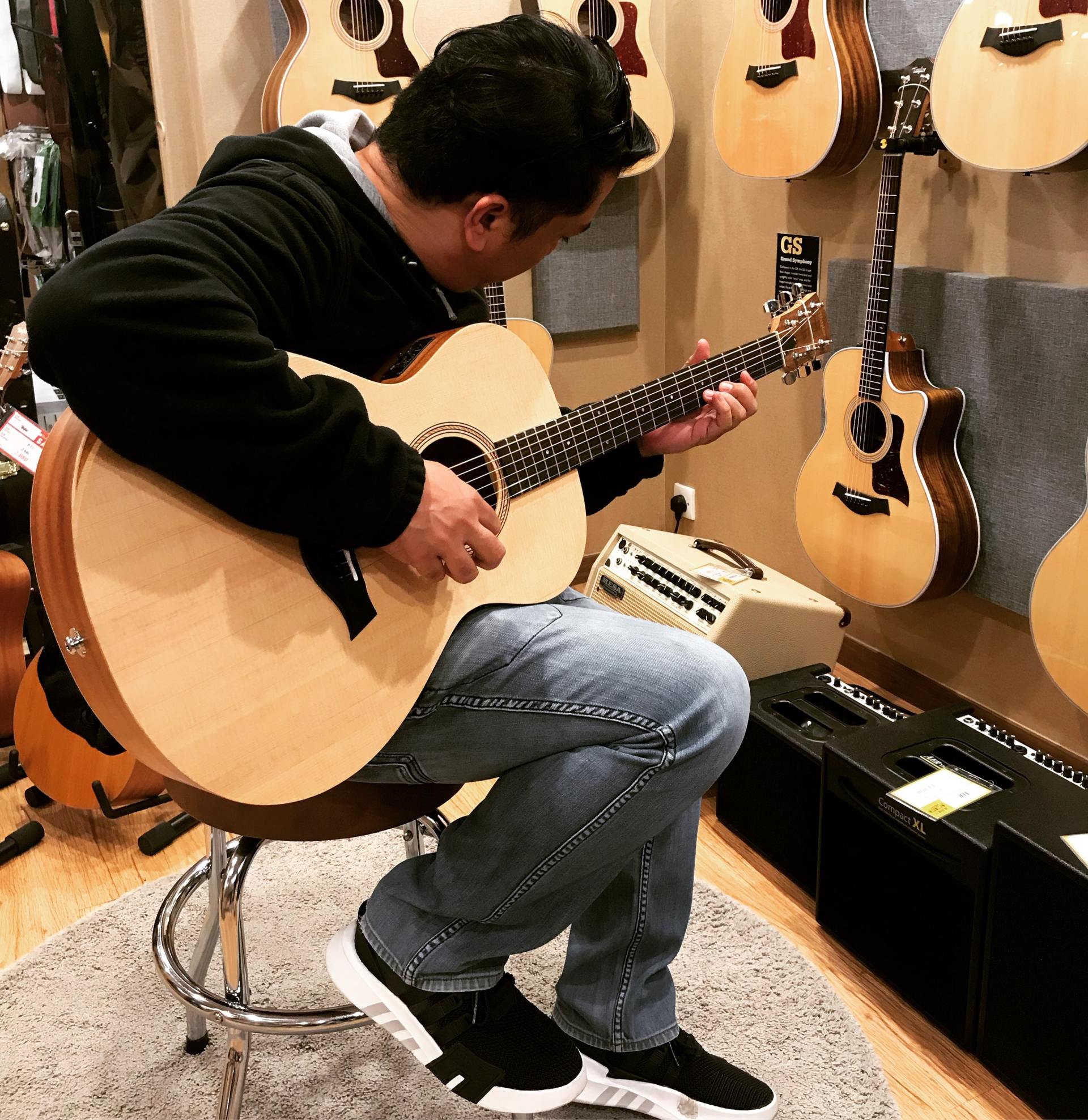 man playing acoustic guitar