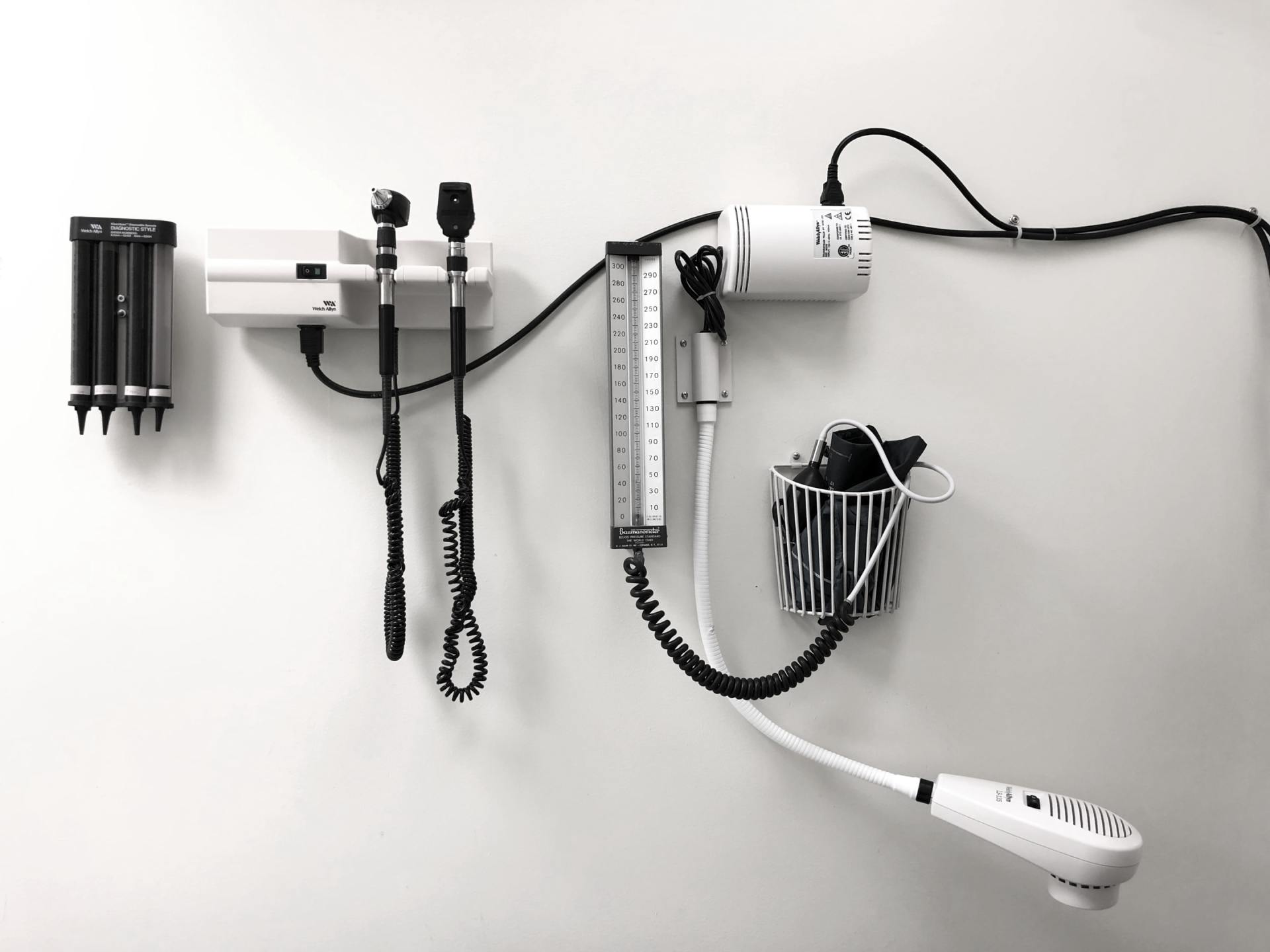 A black and white photo of medical equipment hanging on a wall.