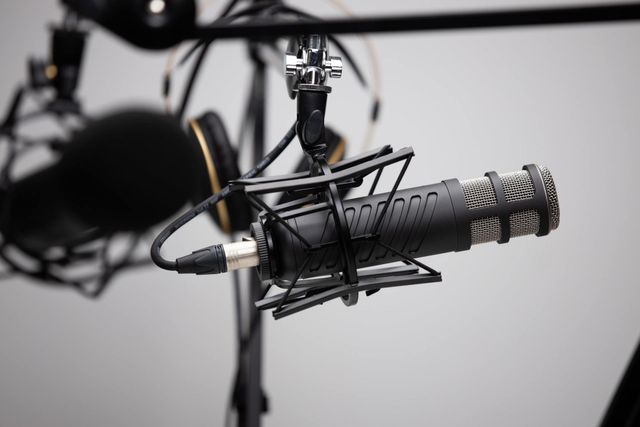 A close up of a microphone and headphones on a stand.