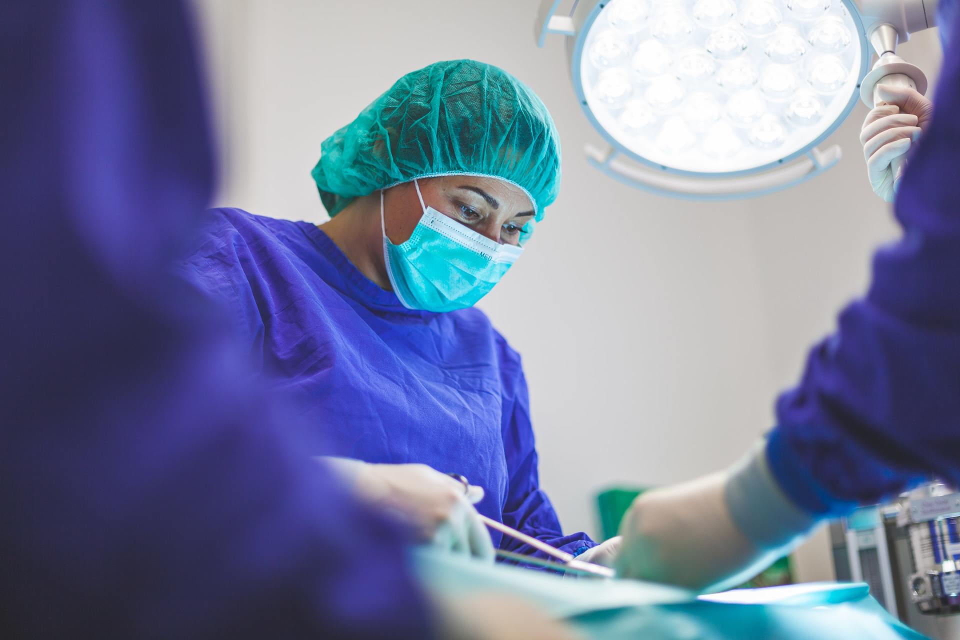 A doctor wearing a face mask during surgery