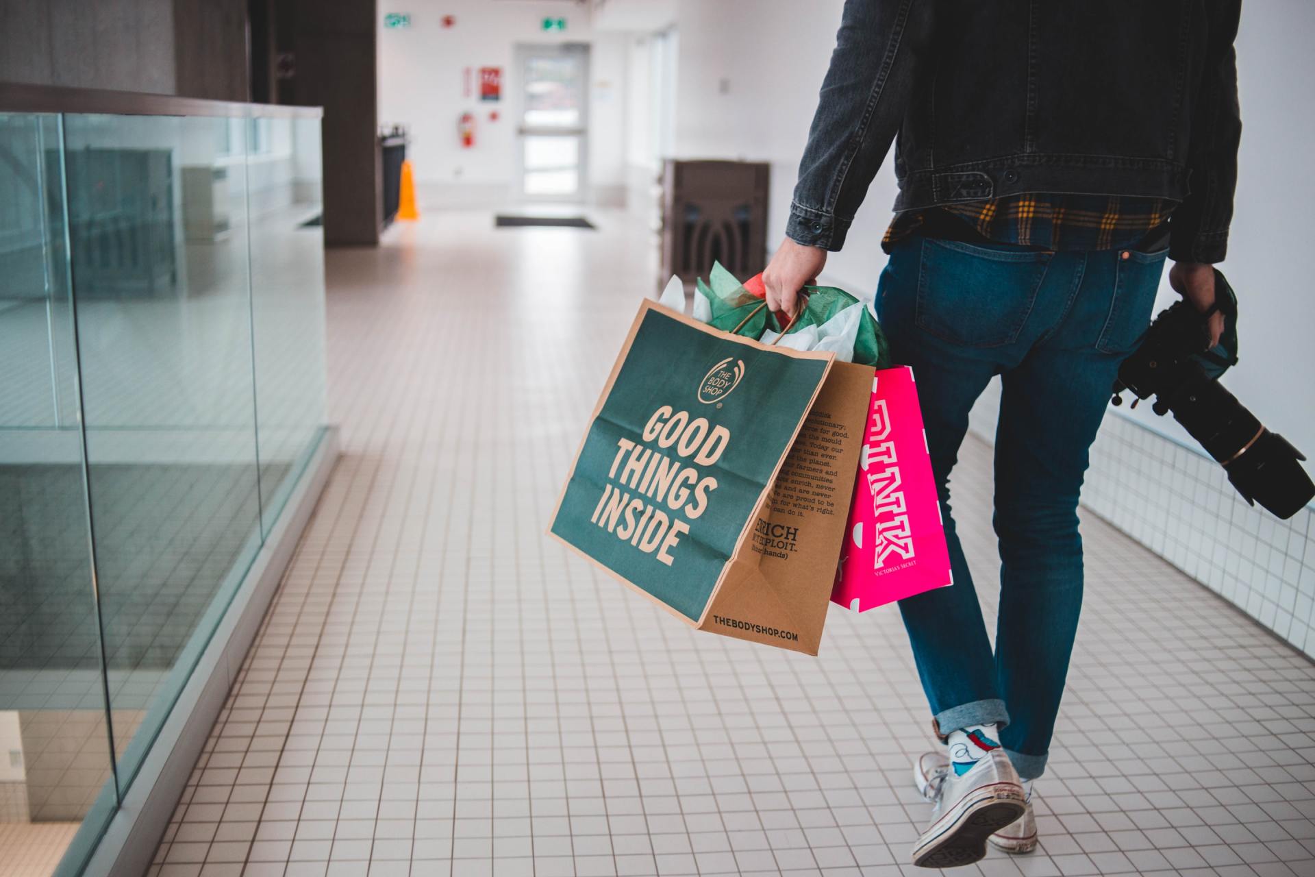 A person carrying shopping bags that say good things inside