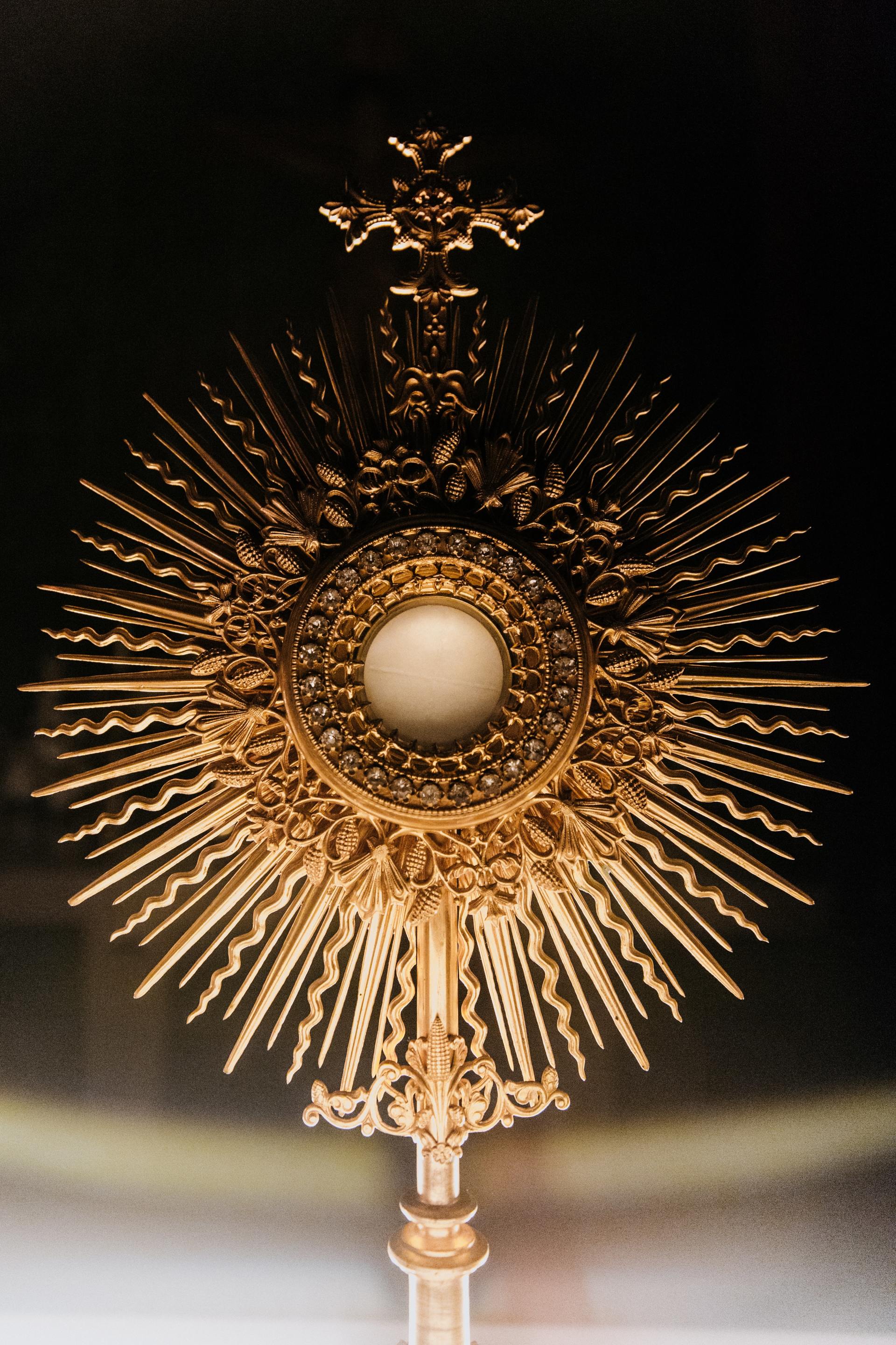 A gold object with a cross on top of it