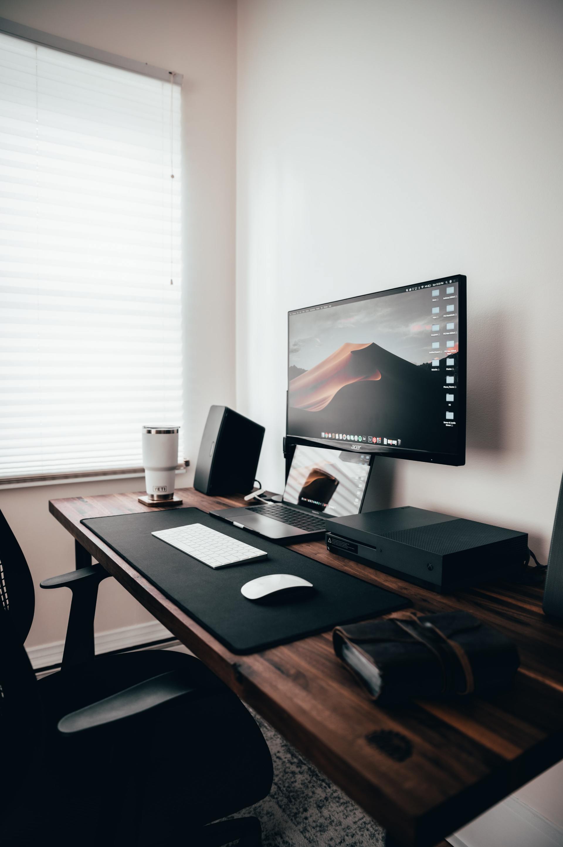 A desk with a computer , keyboard , mouse and speakers on it.