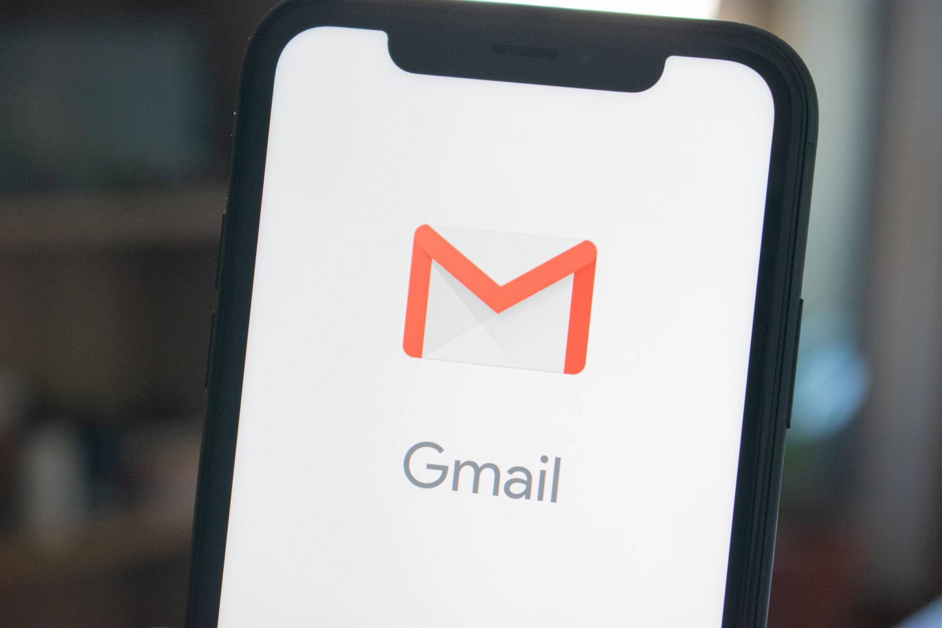 A phone with the gmail app on it