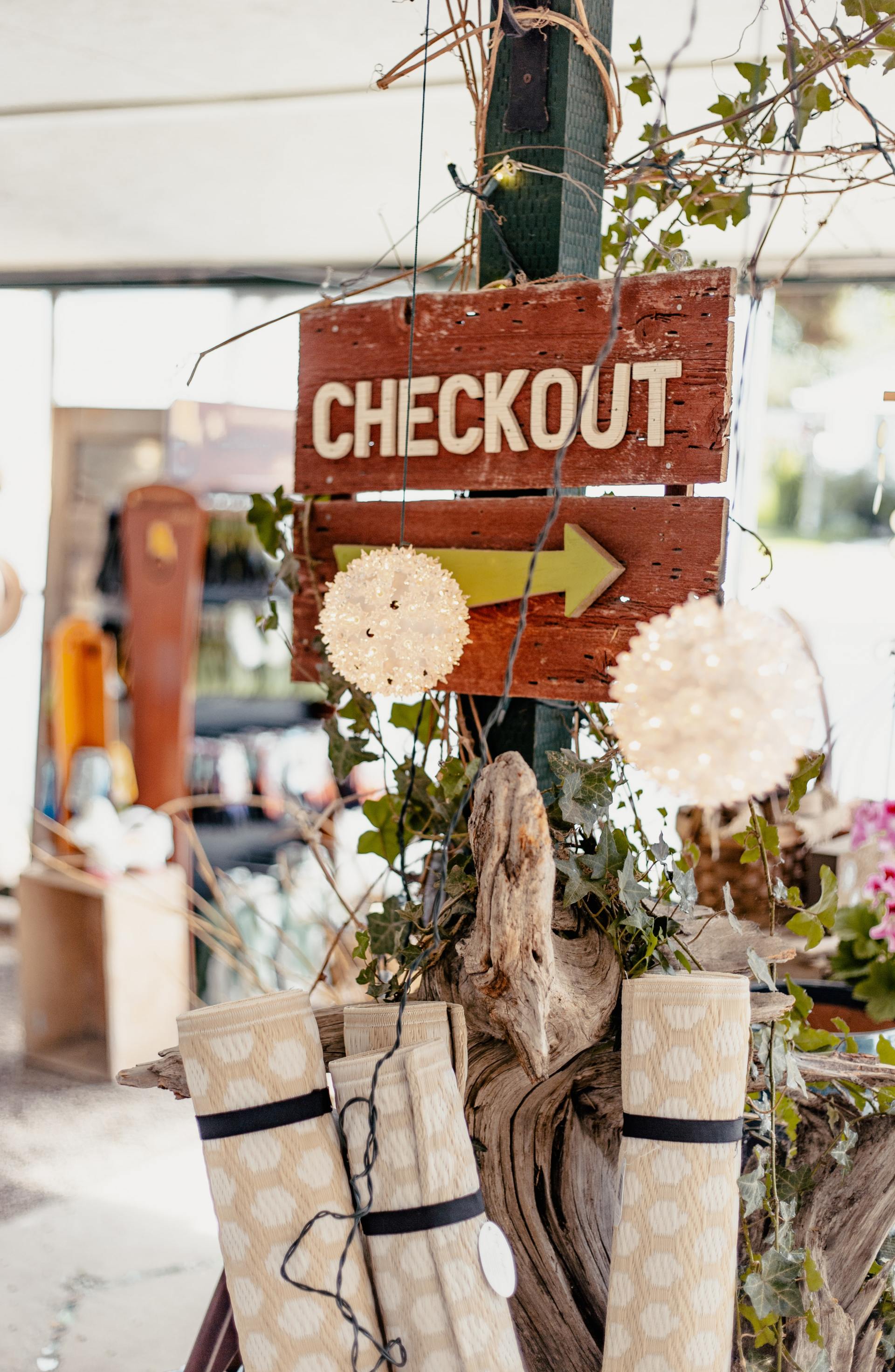 A wooden sign that says checkout on it