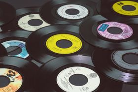 Stacked vinyl records with colorful labels in a close-up view