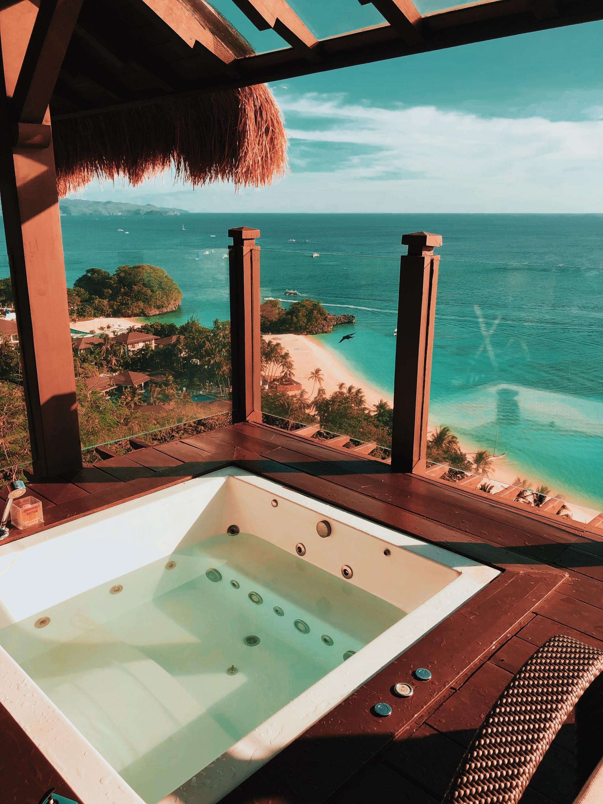 Un jacuzzi sur un balcon avec vue sur l'océan.