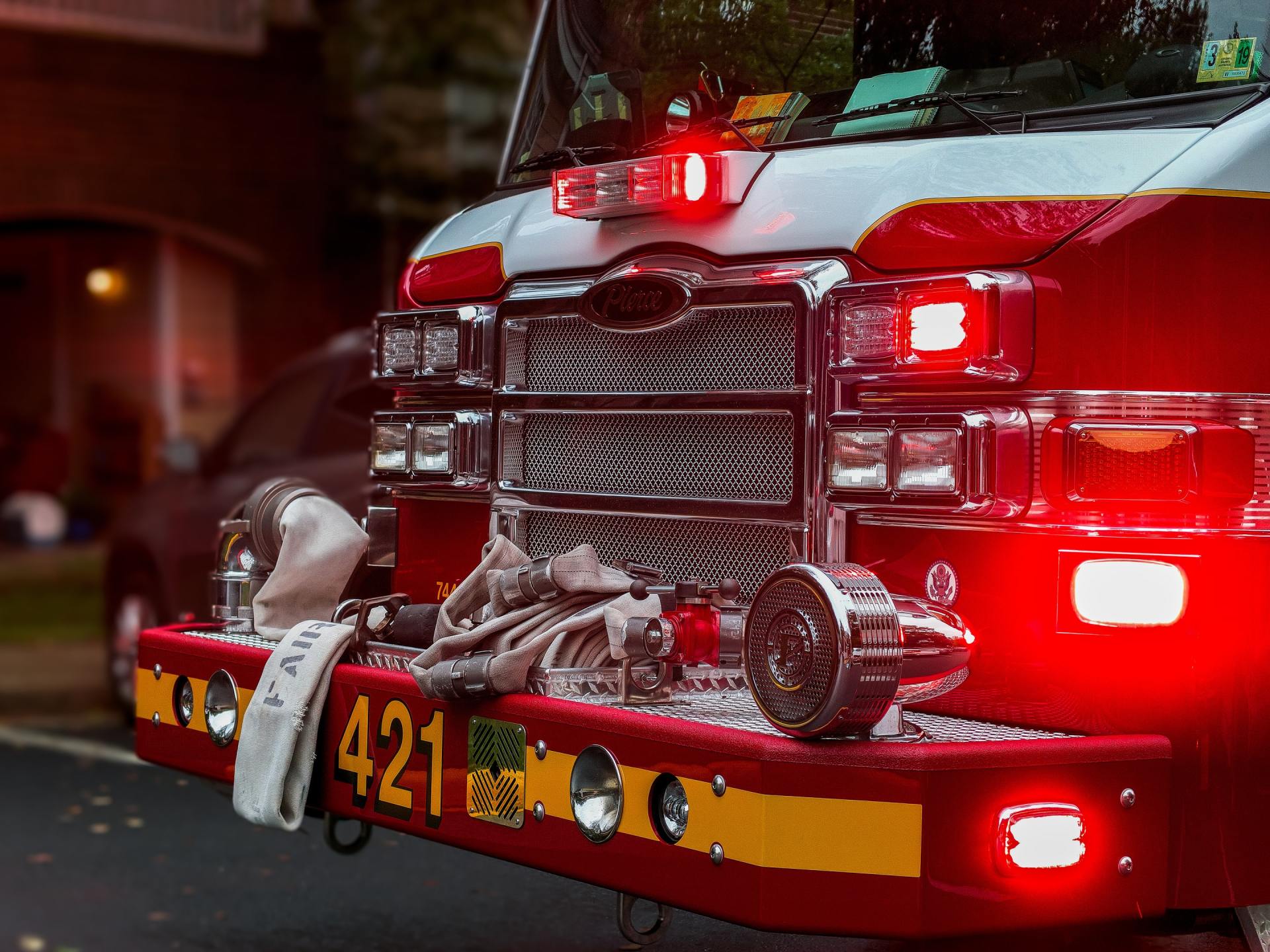 A red fire truck is parked on the side of the road.
