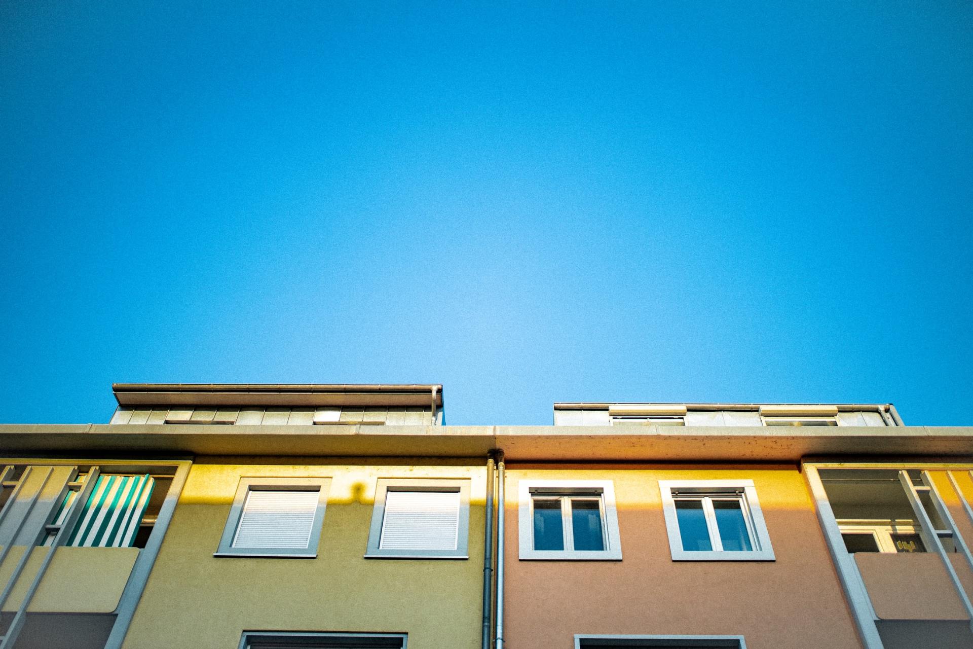 Colorful row houses against a bright blue sky.